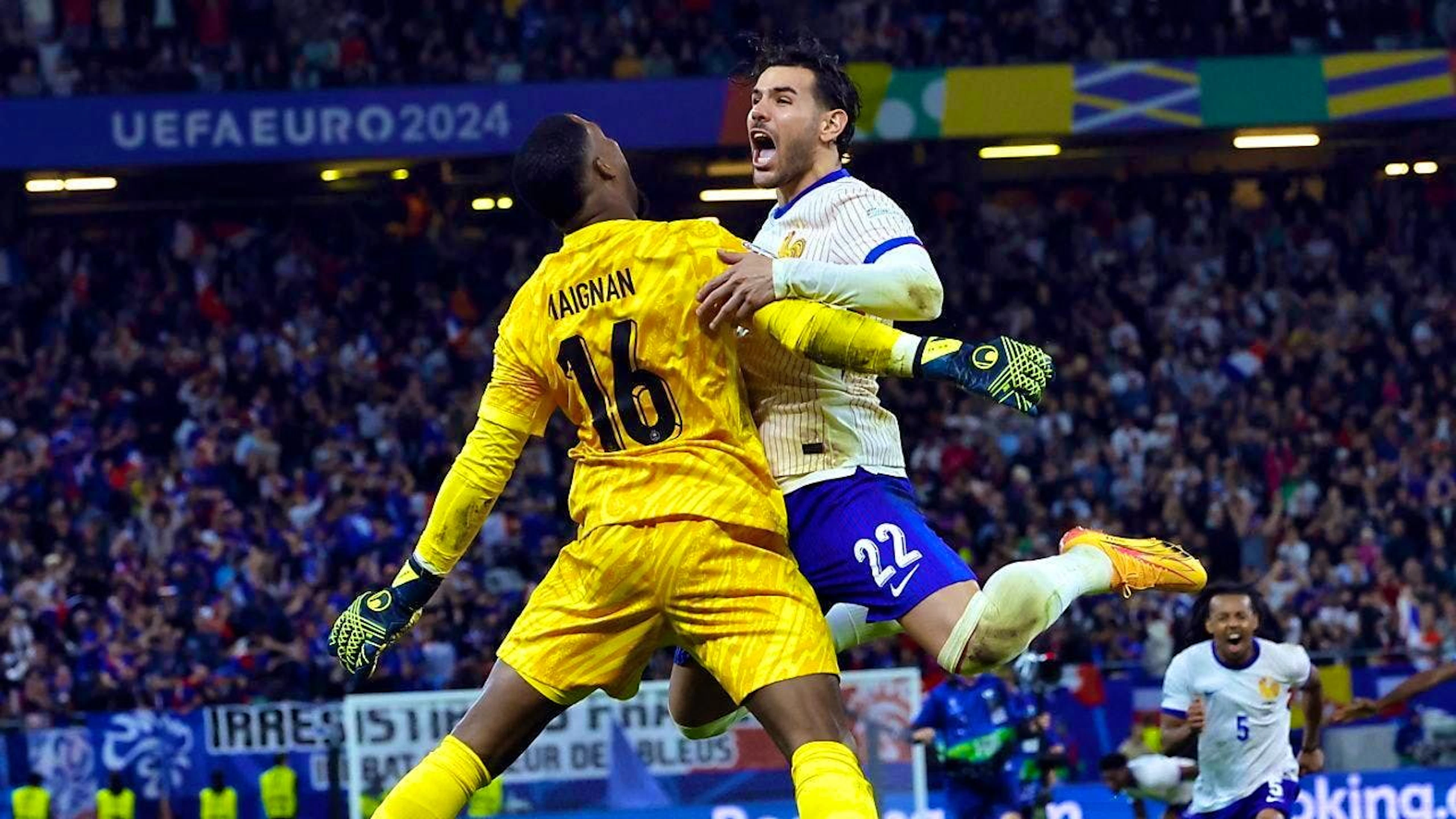 Theo Hernandez and goalkeeper Mike Maignan celebrate after winning the penalty shoot-out