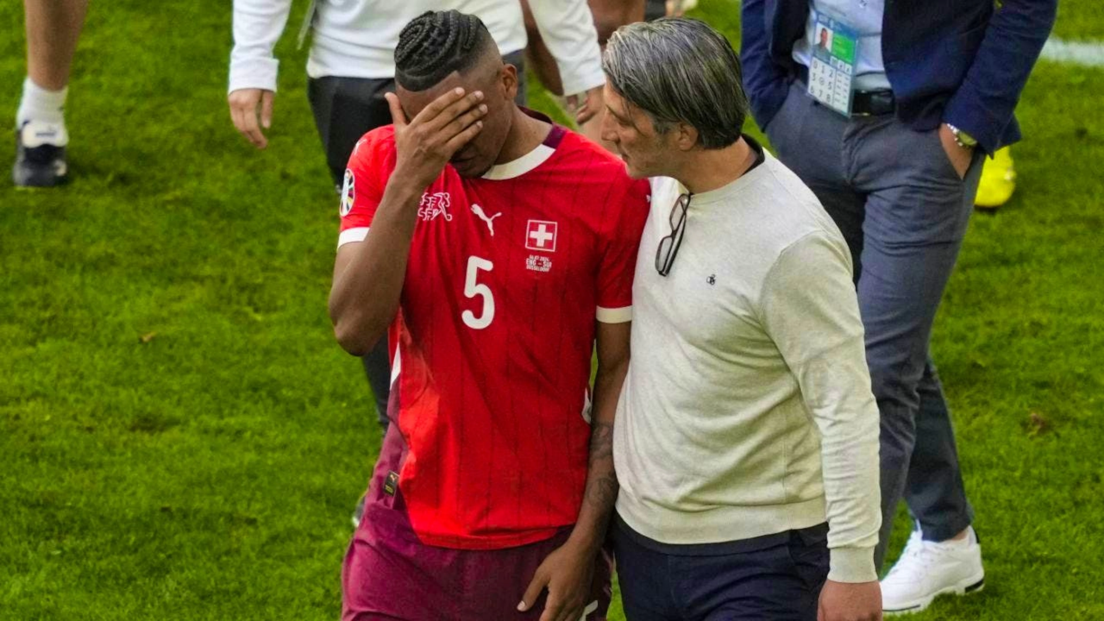 Coach Murat Yakin comforts Manuel Akanji, who misses the penalty shoot-out against England