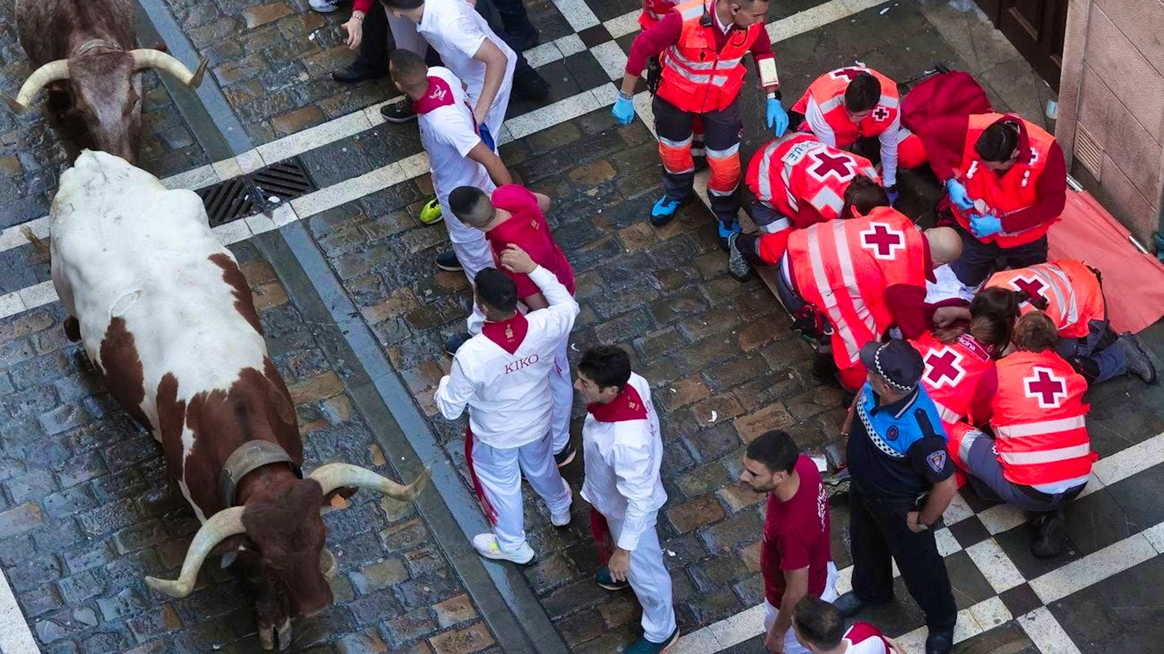 A man is treated by paramedics in Pamplona on July 7.