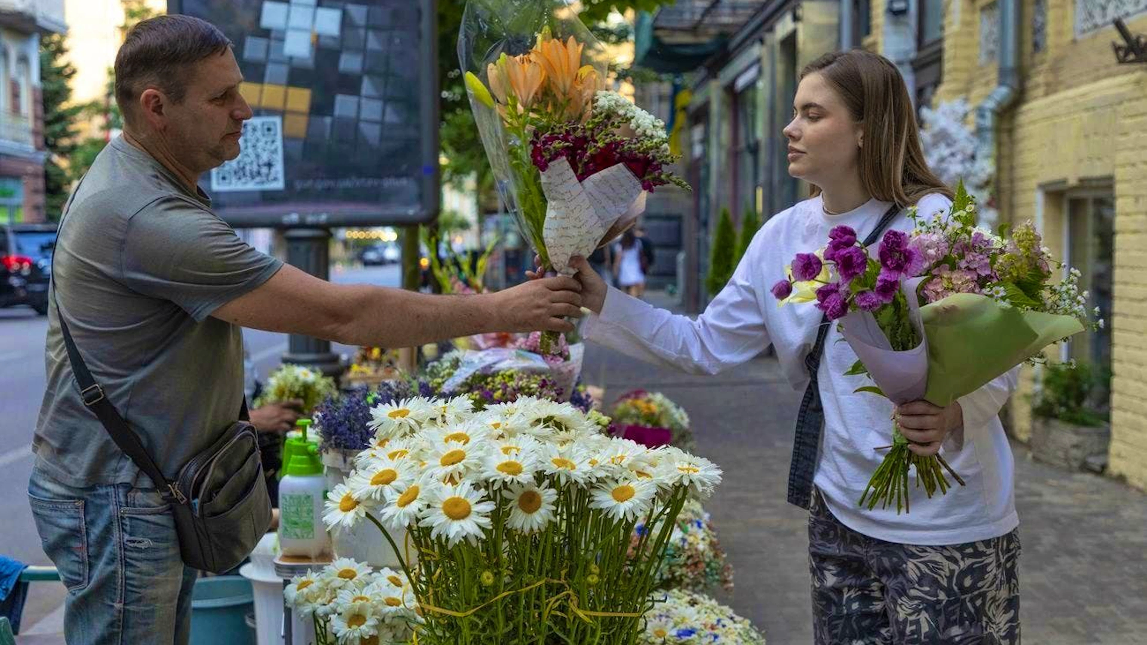 A ray of hope in dark times: A woman buys flowers in Kiev on June 25.