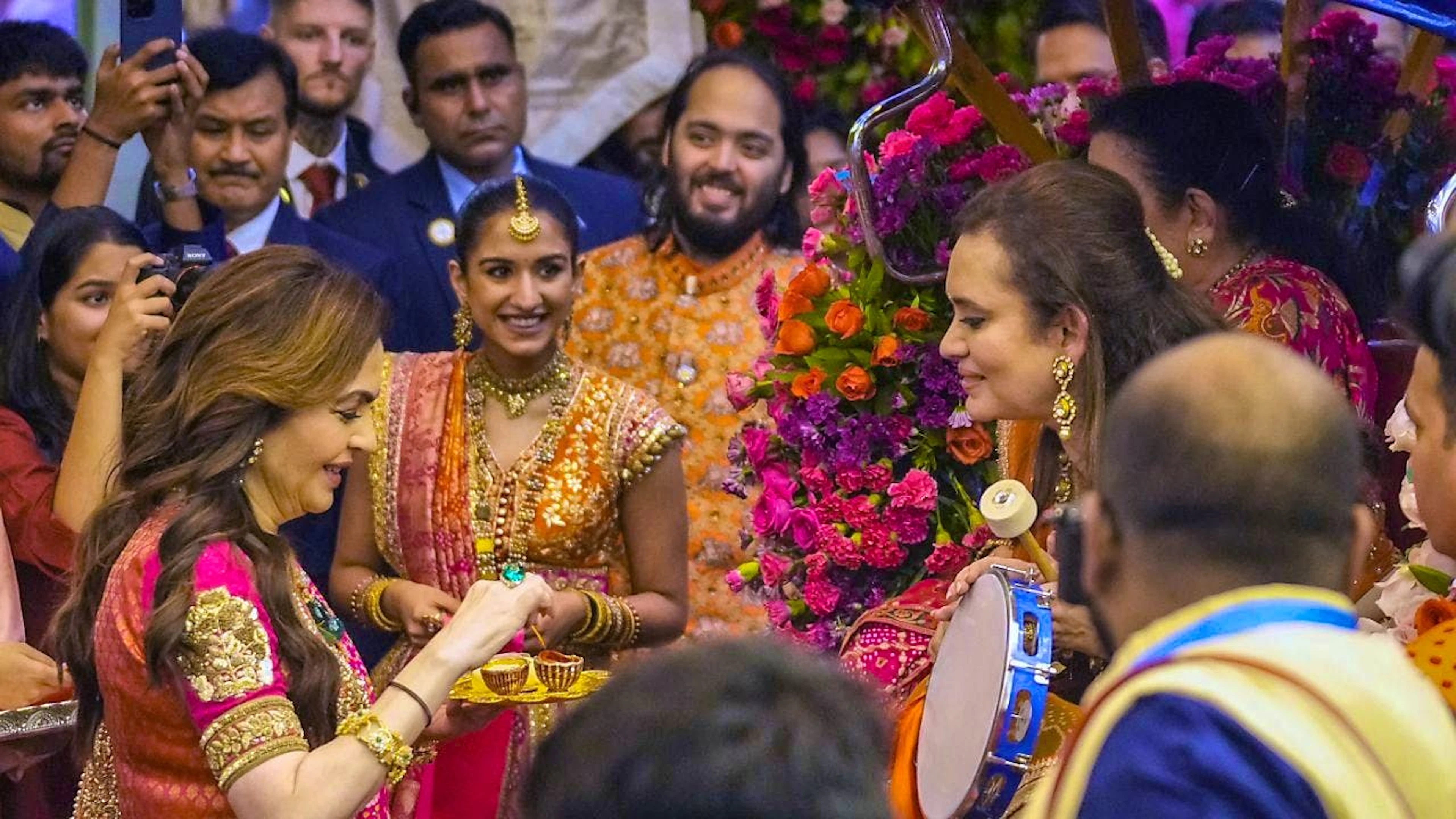 The groom's mother, Nita Ambani, receives guests at one of the many wedding celebrations with thousands of guests. In the background: Radhika Merchant and Anant Ambani.