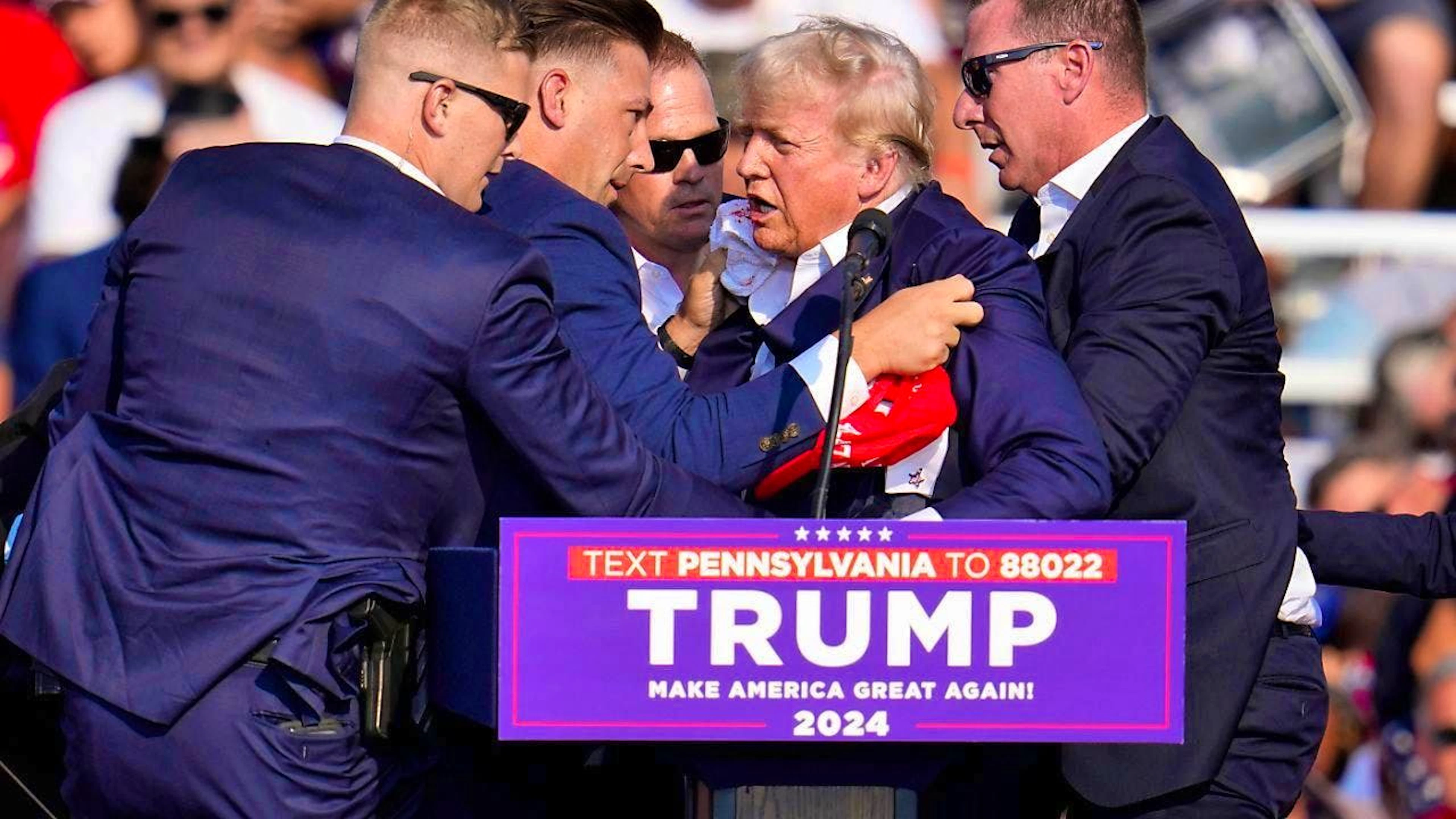 US Secret Service agents help Republican presidential candidate and former US President Donald Trump off the stage at a campaign rally in Butler, Pennsylvania. Photo: Gene J. Puskar/AP/dpa