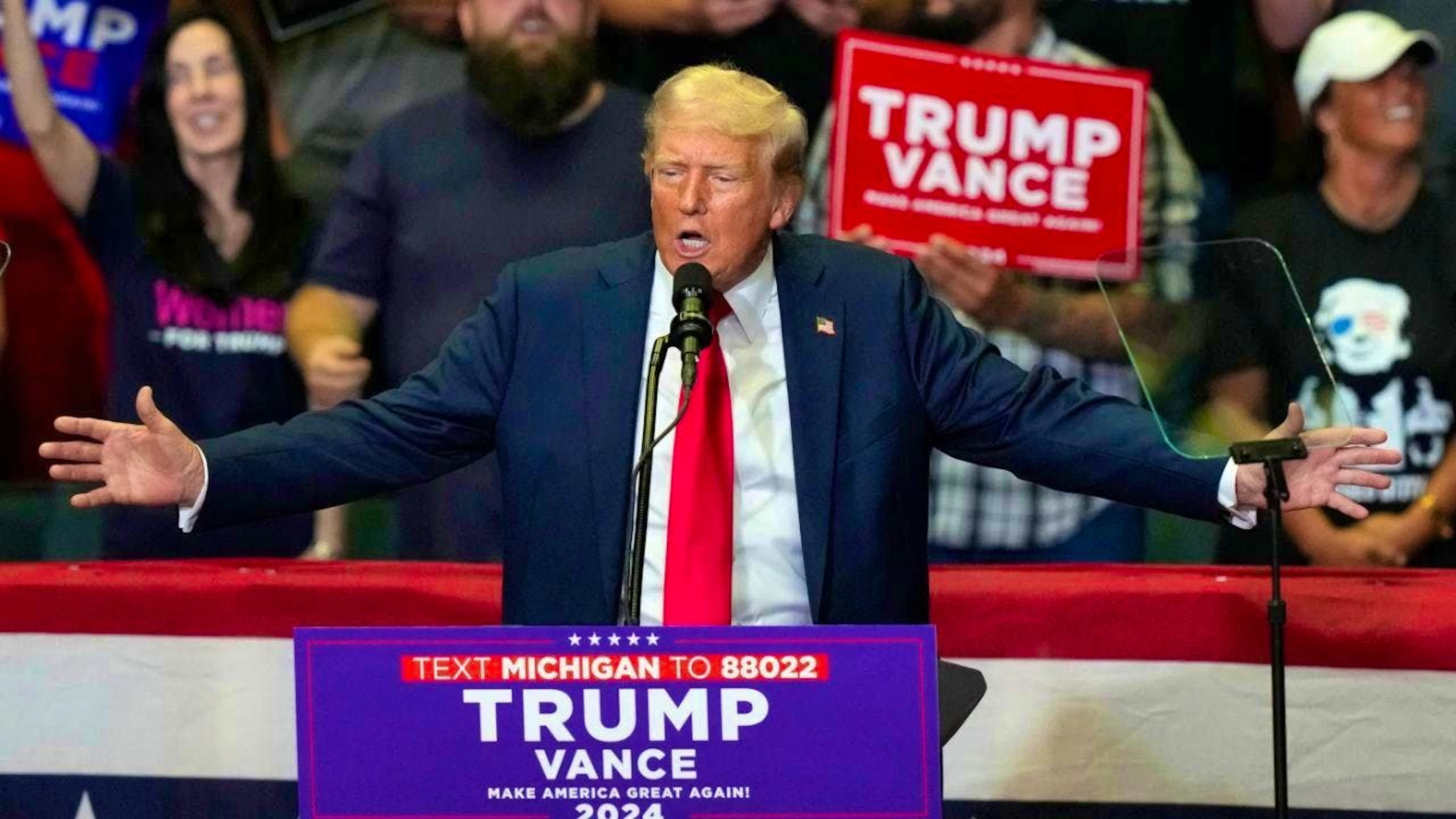 Republican presidential candidate and former US President Donald Trump speaks at a campaign rally at the Van Andel Arena in Grand Rapids.
