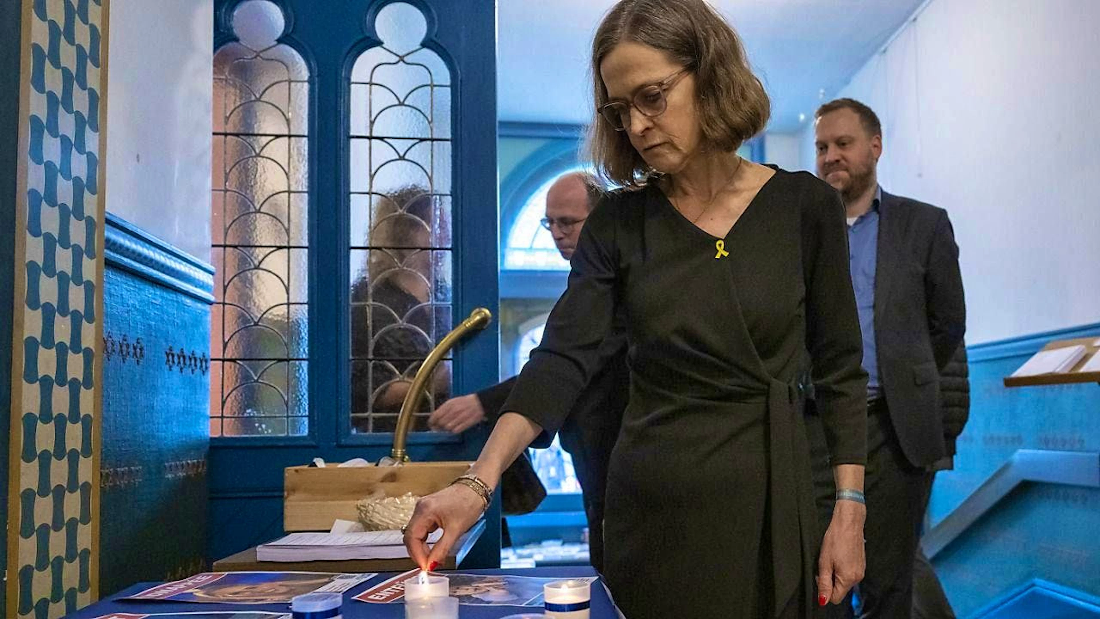 Ifat Reshef, Israel's ambassador to Switzerland, lights a candle at a memorial event in the Bern Synagogue.