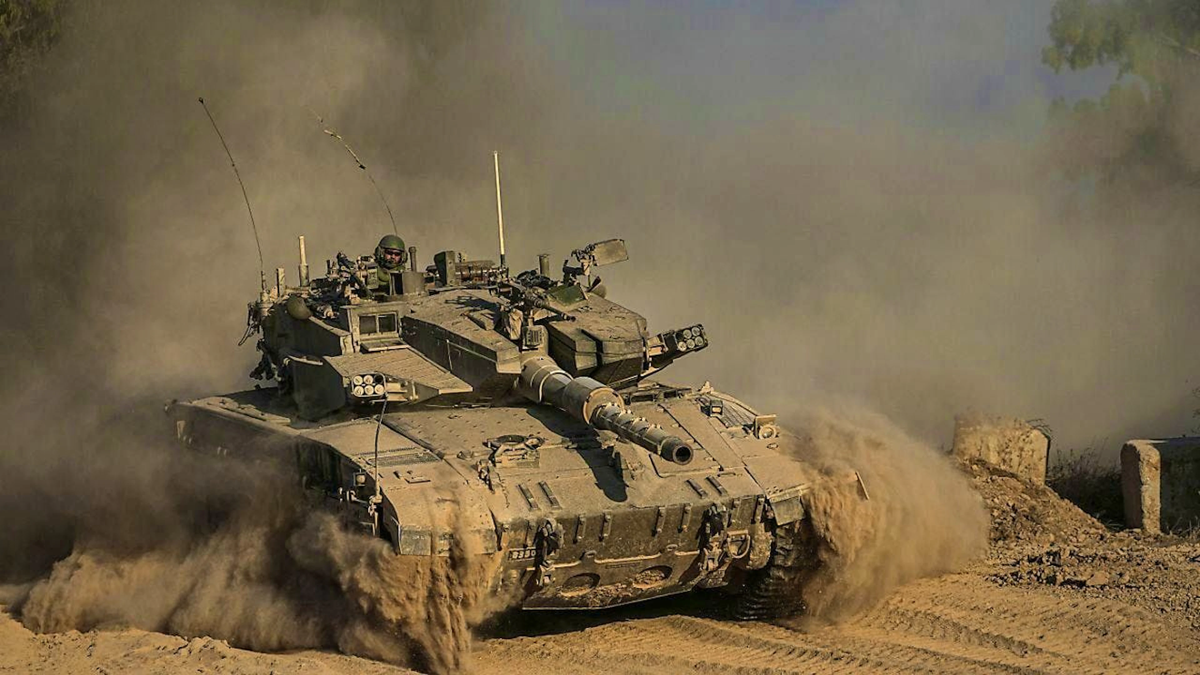 ARCHIVE - An Israeli soldier sits on a tank during a patrol on the border strip. Photo: Tsafrir Abayov/AP/dpa