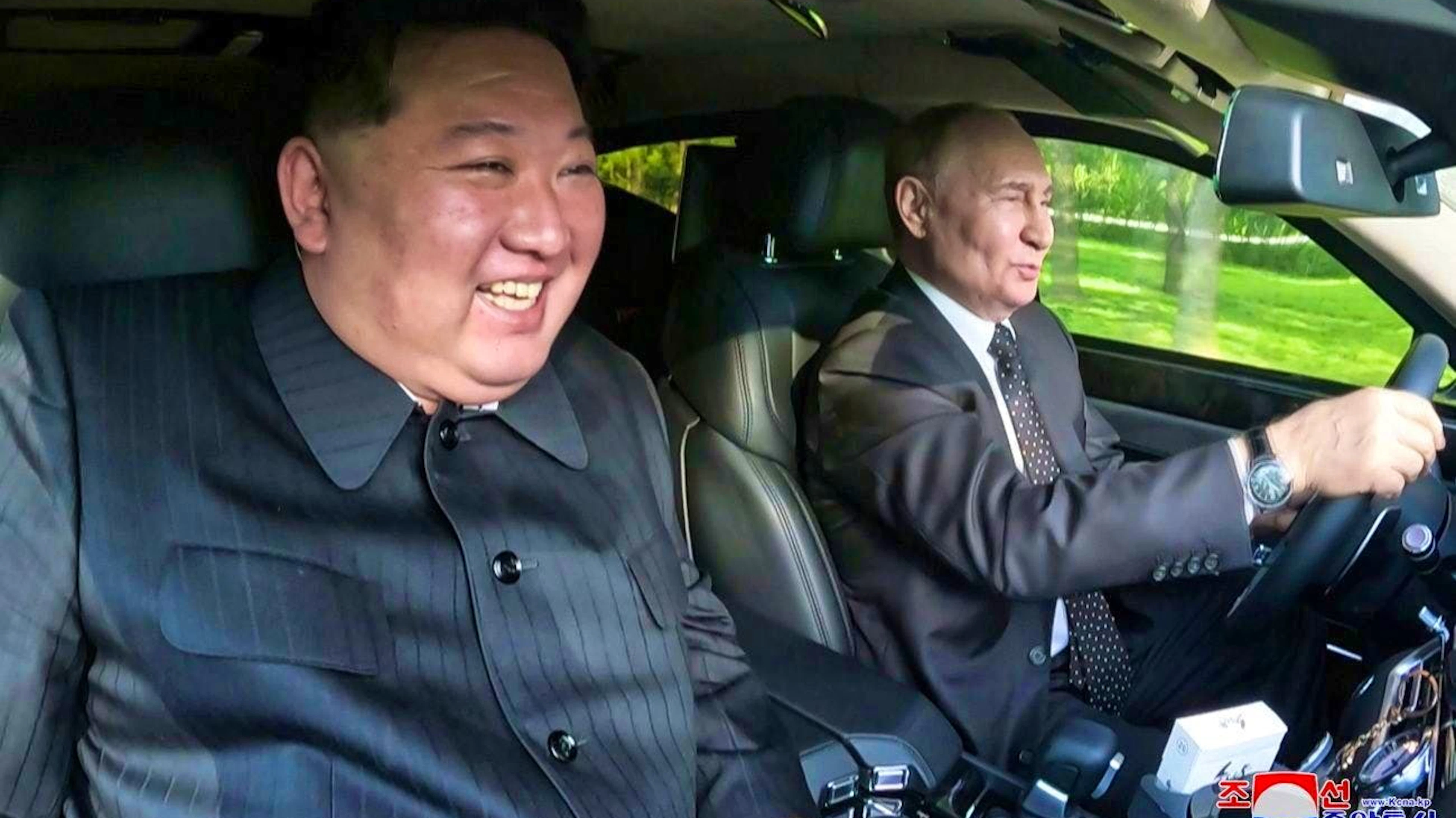 Vladimir Putin (r.) chauffeurs Kim Jong-un around Pyongyang in a Russian luxury Aurus limousine on June 19.