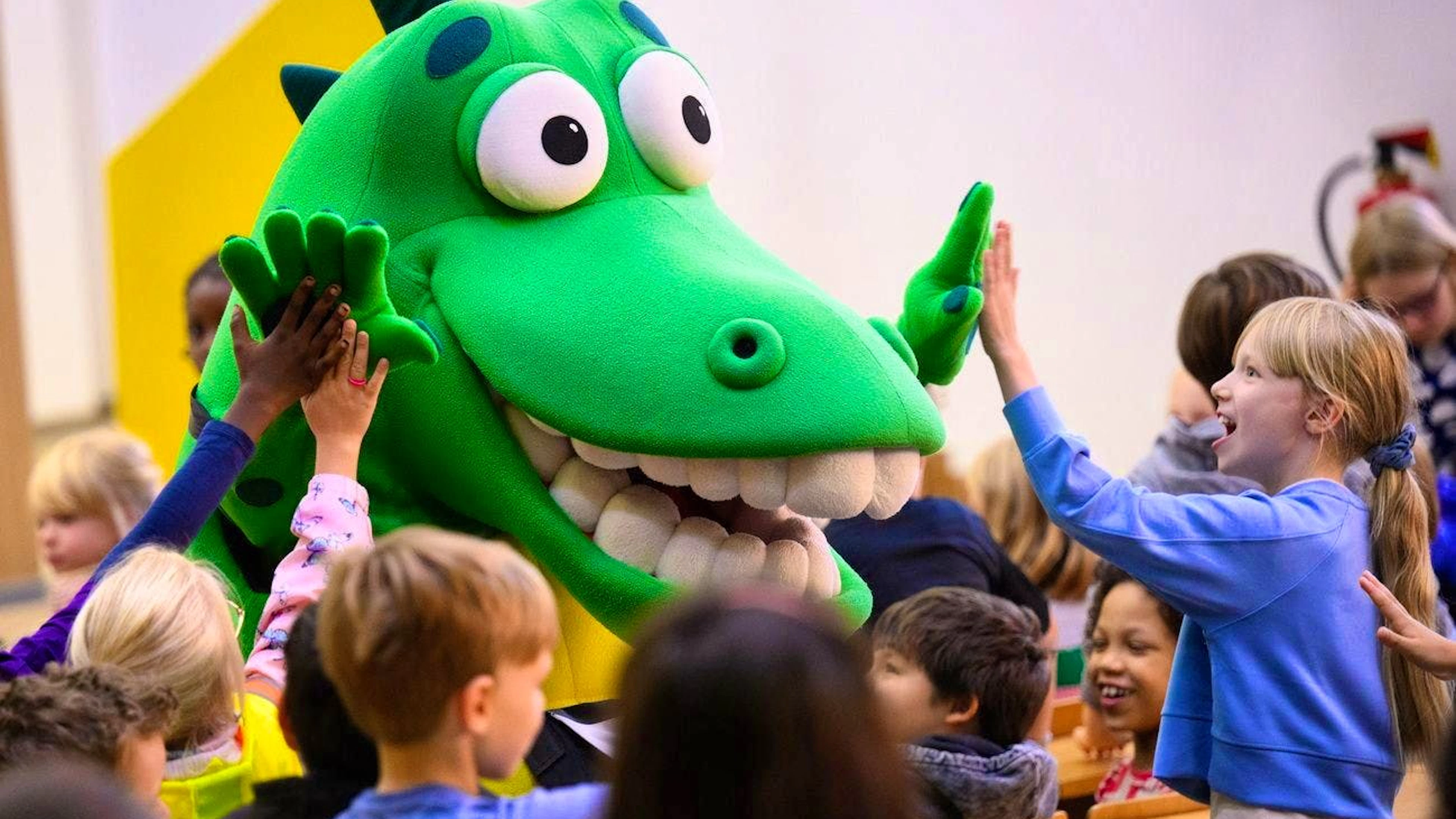 Kroko, the toothbrushing crocodile, looks after Berlin's children: poor families with lots of children are also likely to feel the effects of the government crisis.