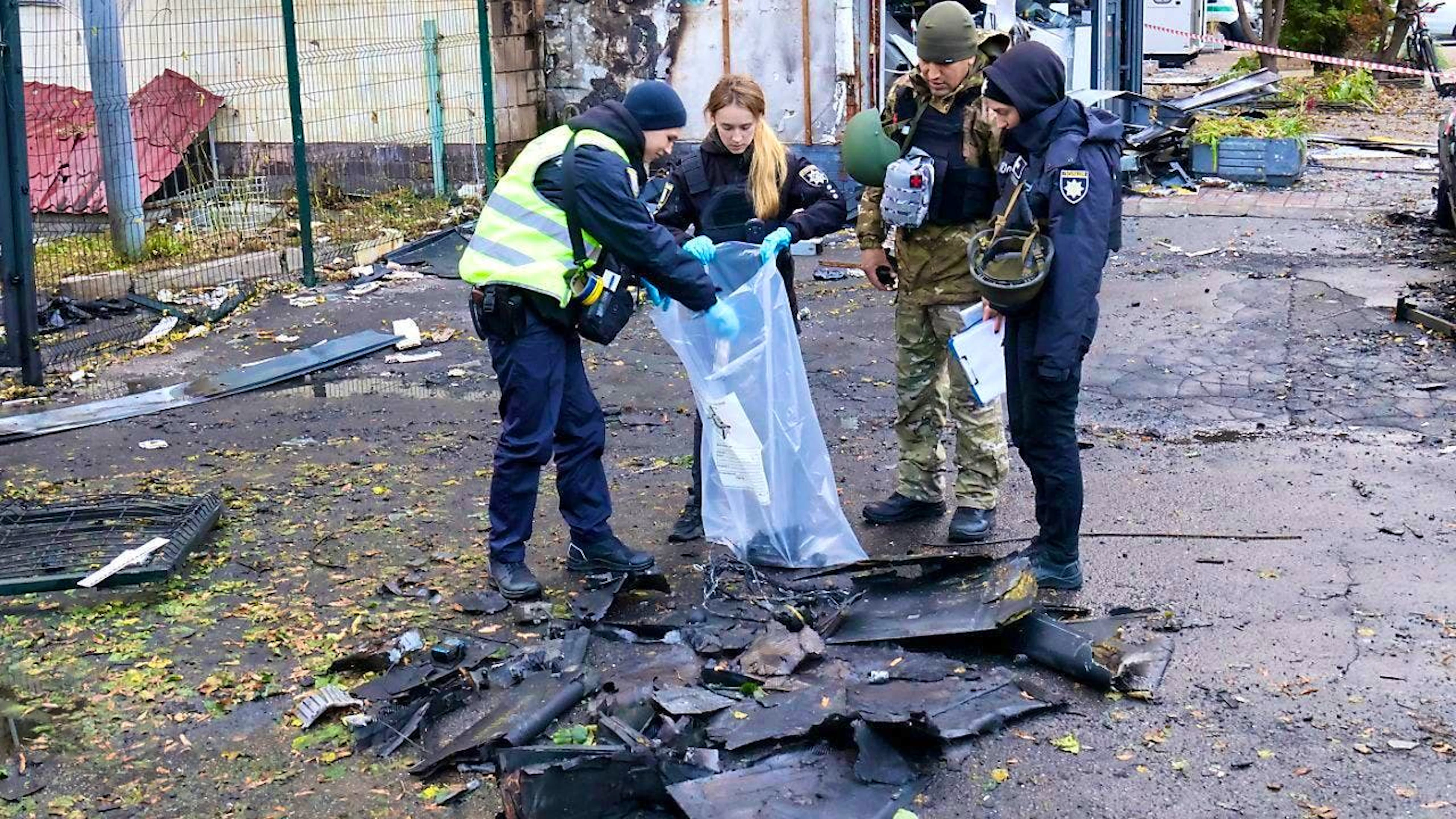 ARCHIVE - Law enforcement officers pick up the fragments of a Russian drone after a Russian drone attack. Debris from downed combat drones caused fires in the Ukrainian capital Kiev on Monday night. Photo: --/Ukrinform/dpa