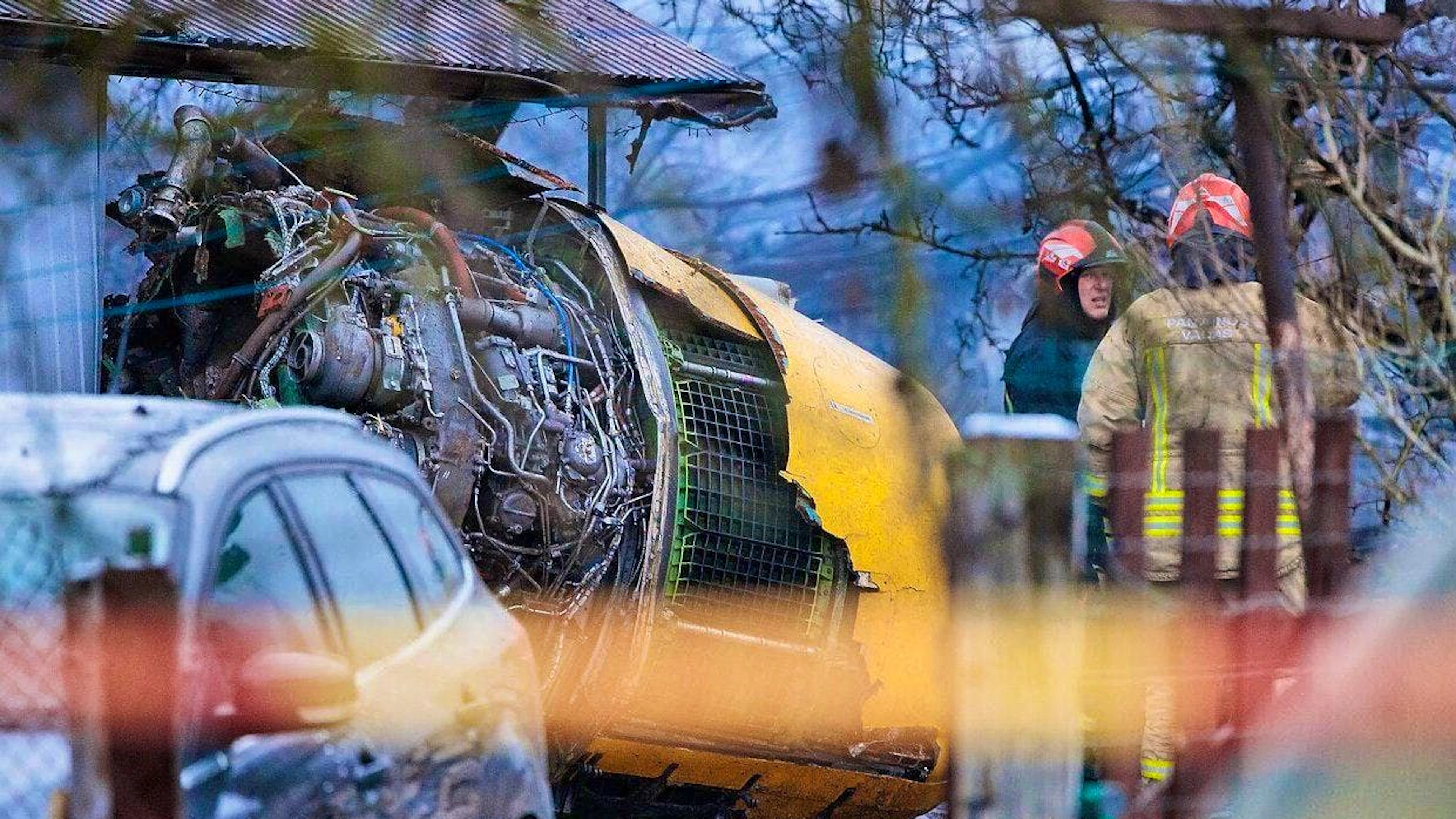 Aircraft debris is scattered around the crash site.