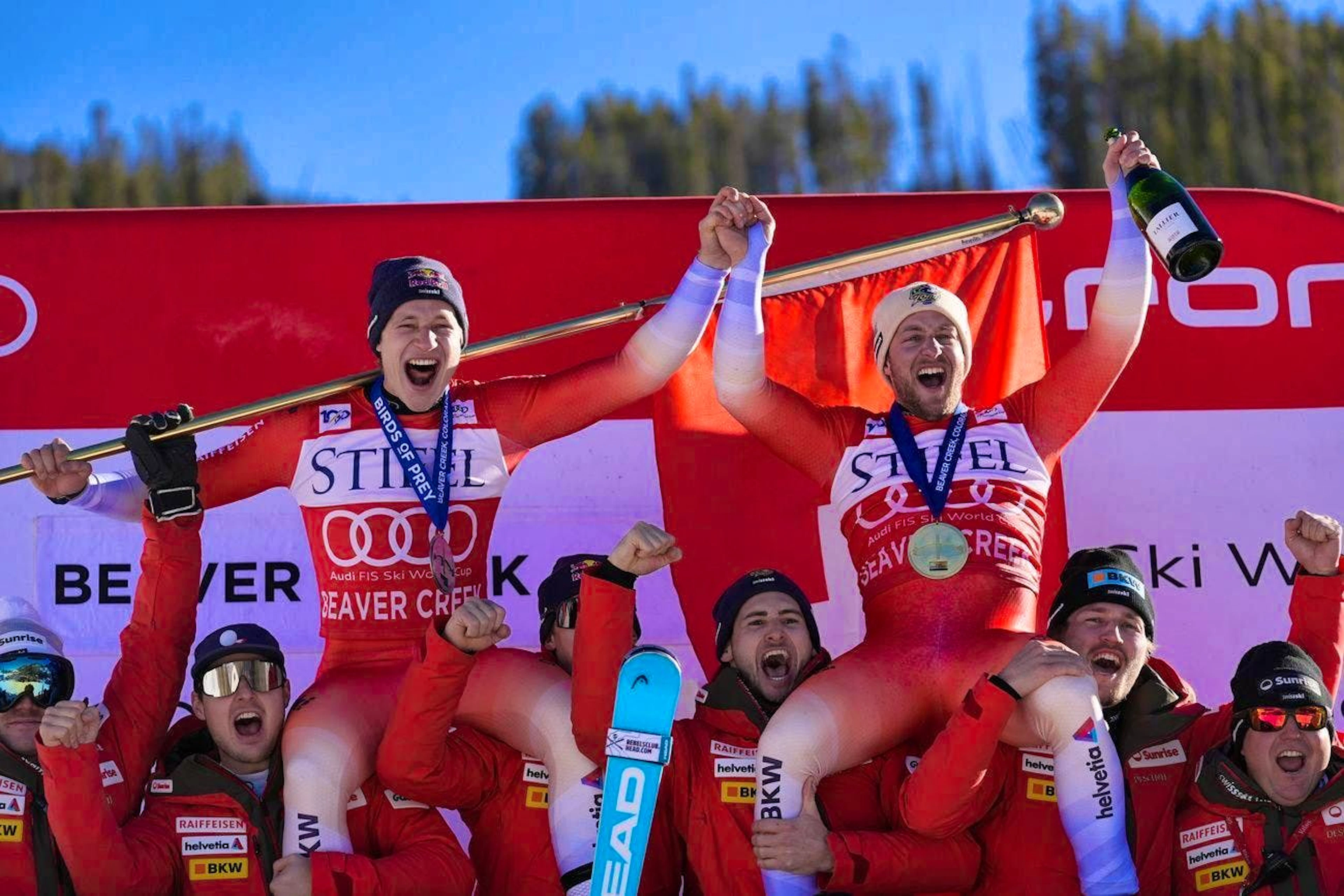 Justin Murisier (right) and Marco Odermatt are celebrated by the Swiss team after their double victory.