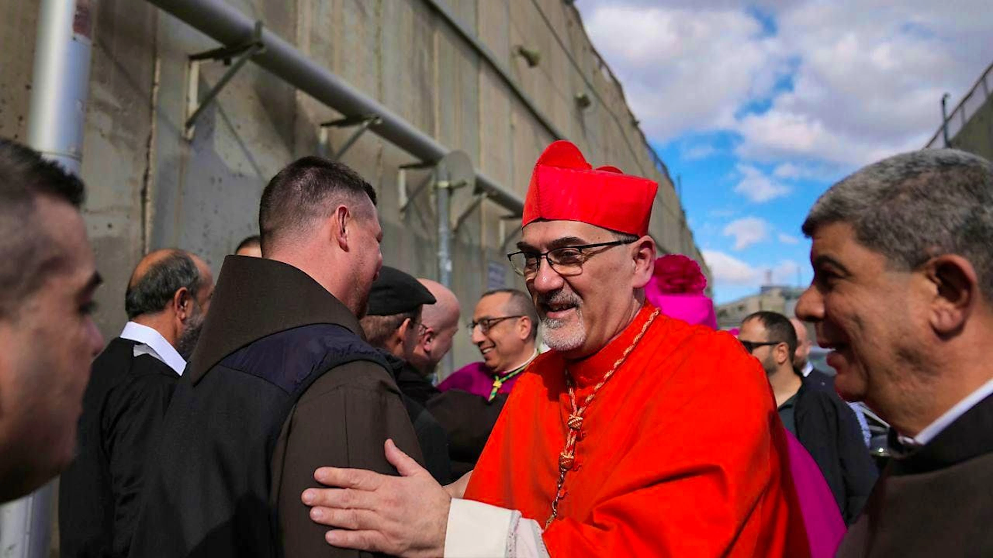 Archbishop Pierbattista Pizzaballa, the top Roman Catholic cleric in the Holy Land, is welcomed by the local community as he passes through an Israeli military checkpoint from Jerusalem. Photo: Nasser Nasser/AP/dpa