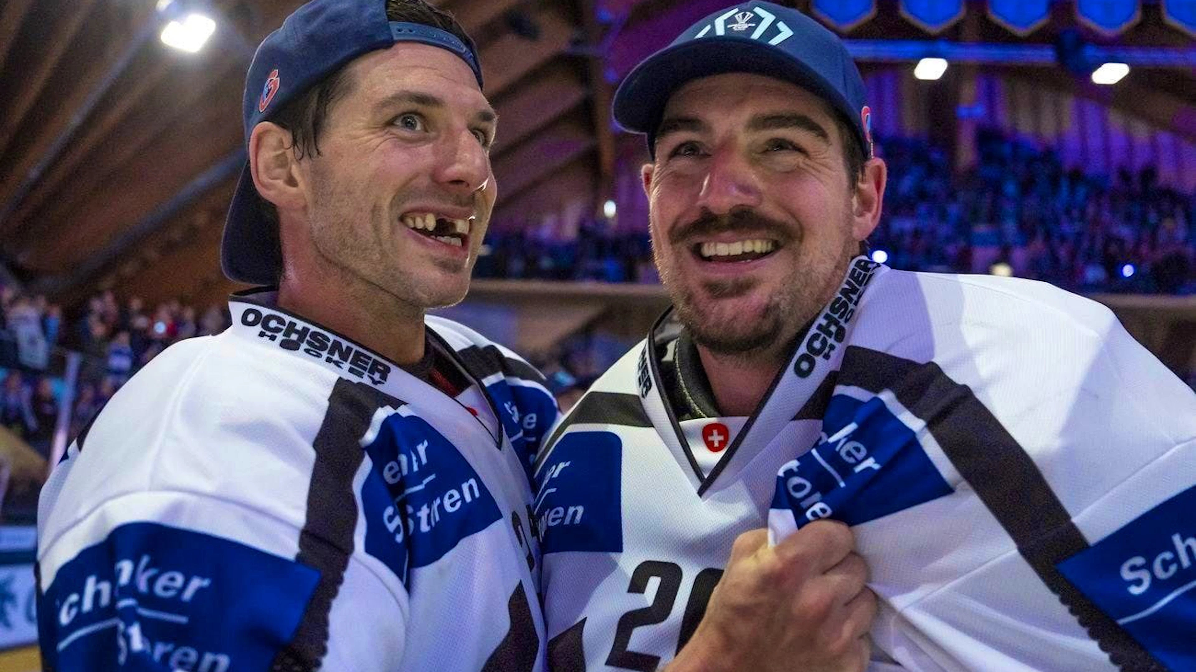 Samuel Walser and Reto Berra celebrate after winning the Spengelr Cup.