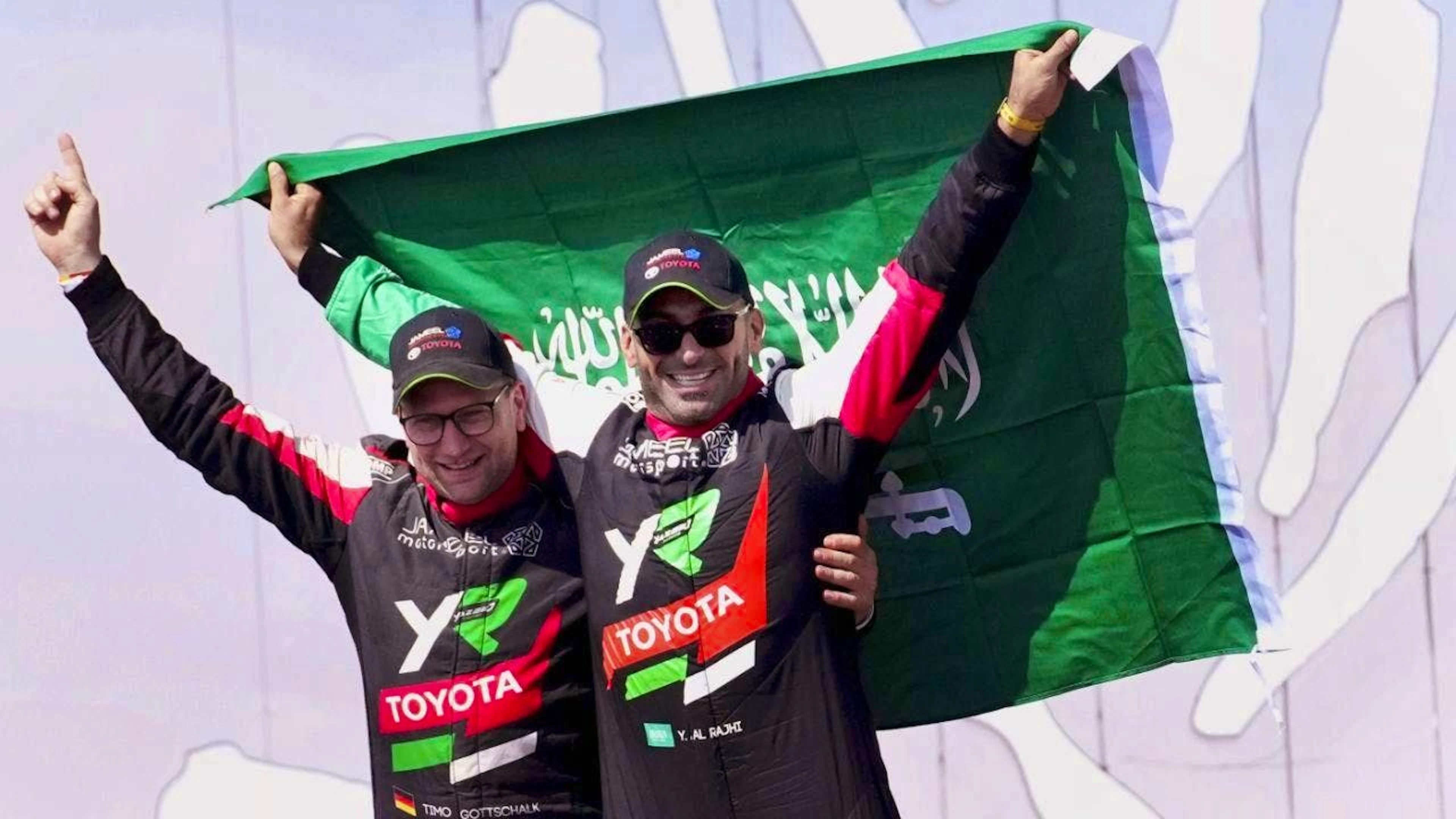 Yazeed al-Rajhi (right) and his co-driver Timo Gottschalk celebrate overall victory in the Dakar Rally after the twelfth stage