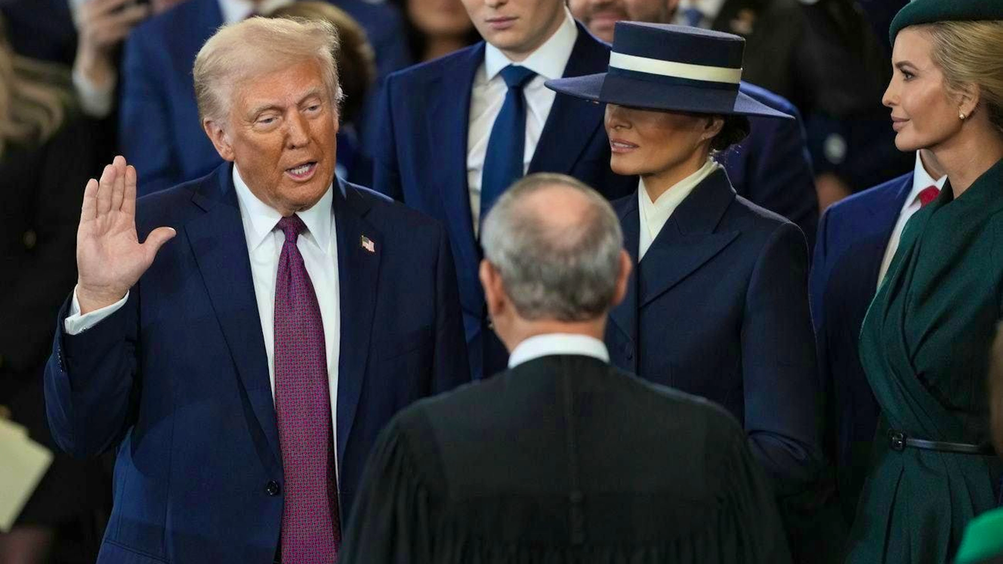 Swearing-in ceremony: son Barron looks on in the background. Daughter Ivanka stands on the right.