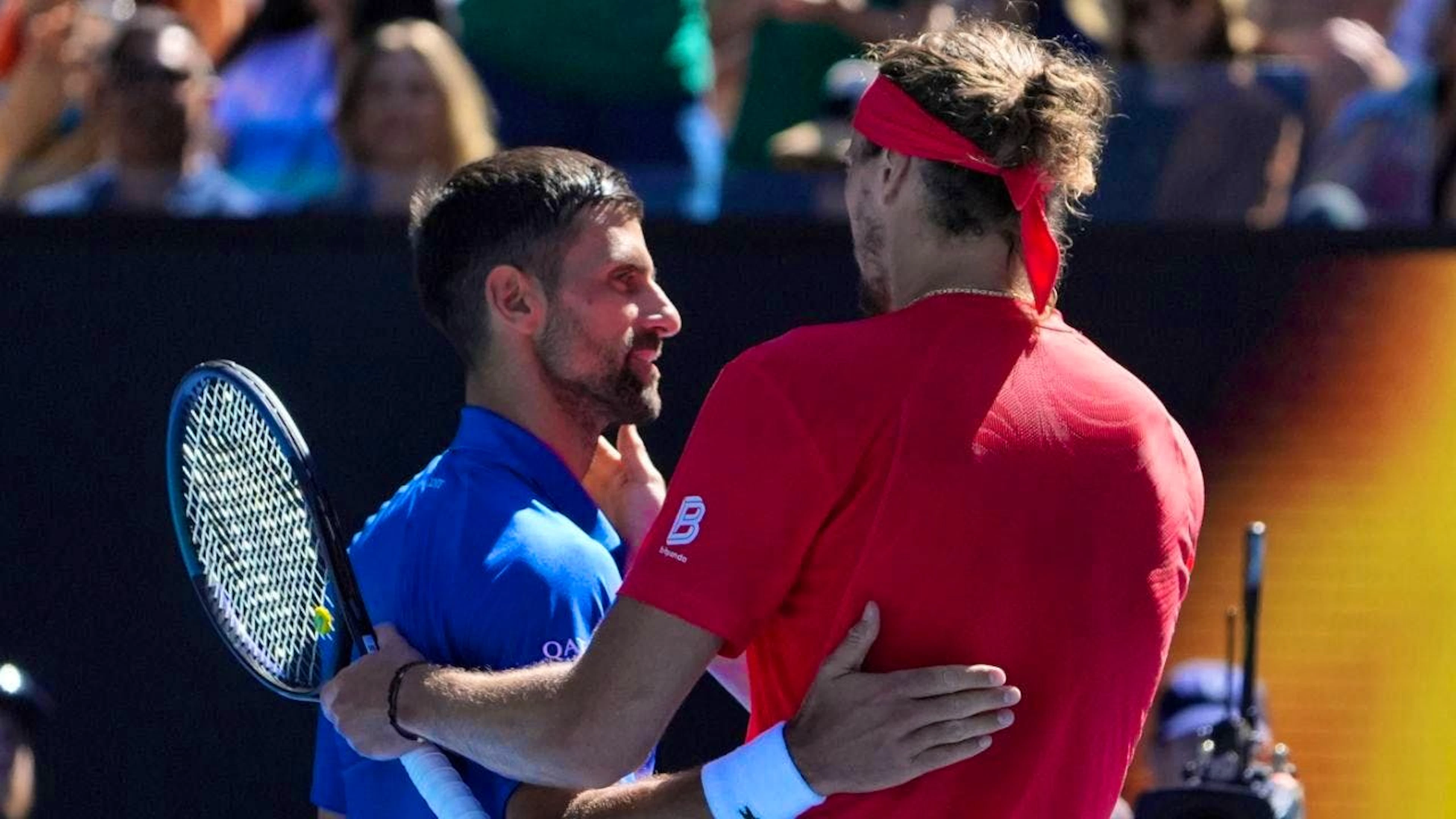 Alexander Zverev (right) benefits from the retirement of Serb Novak Djokovic