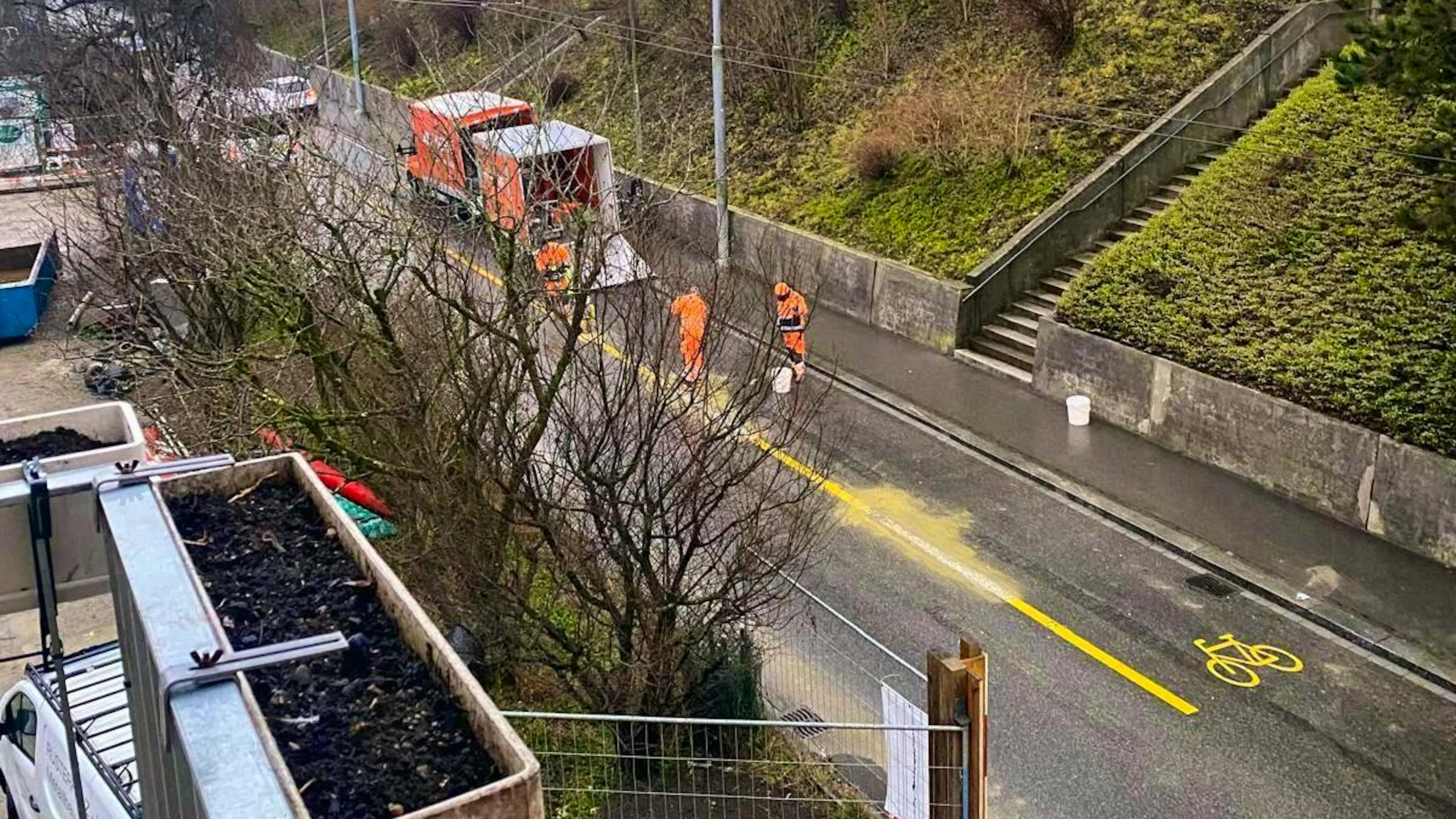 A blue News reader snaps a picture of the construction workers reworking the line near the cycle path.