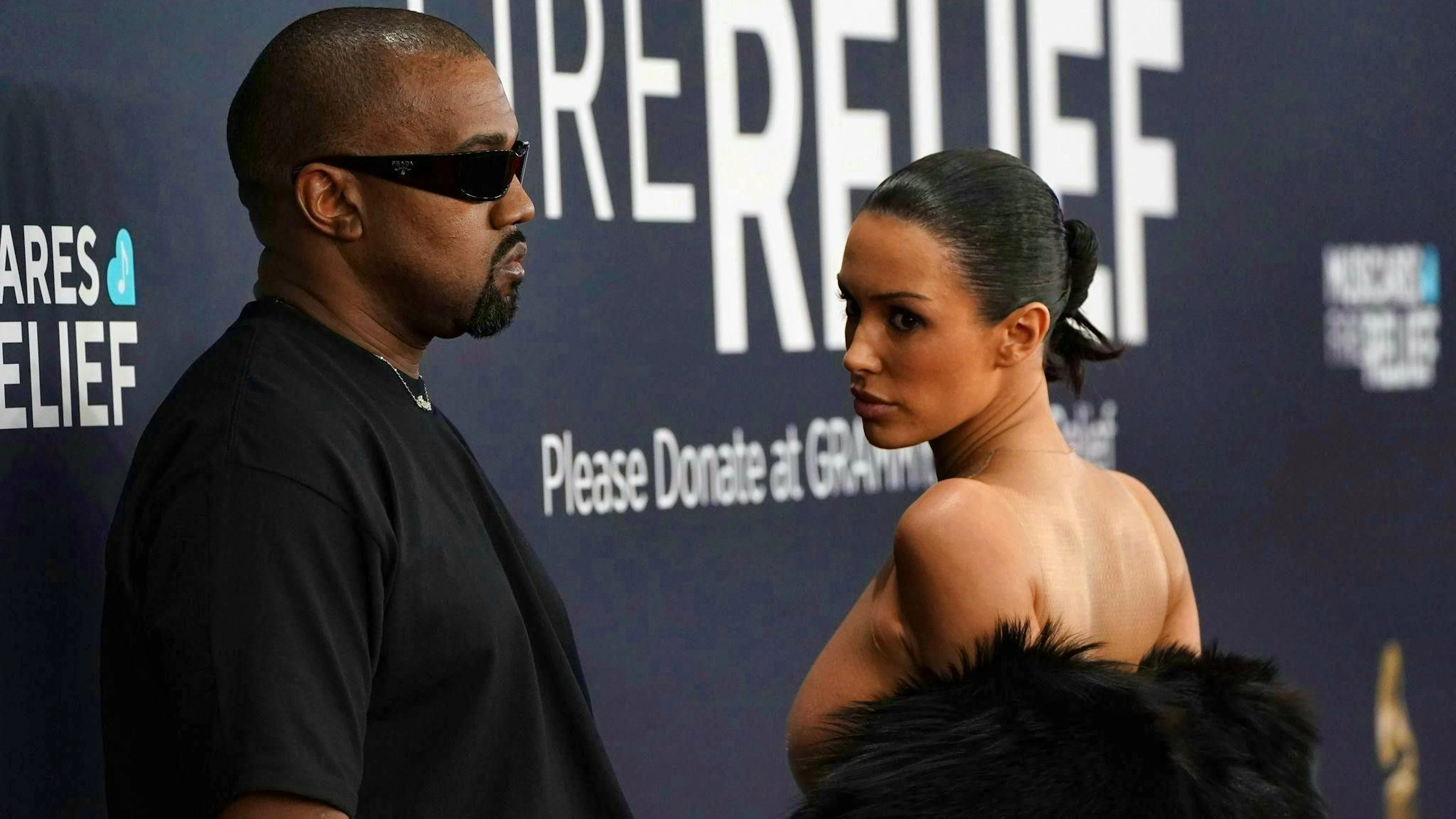 Kanye West with Bianca Censori, who wore little more than a sheer bodystocking under her coat.
