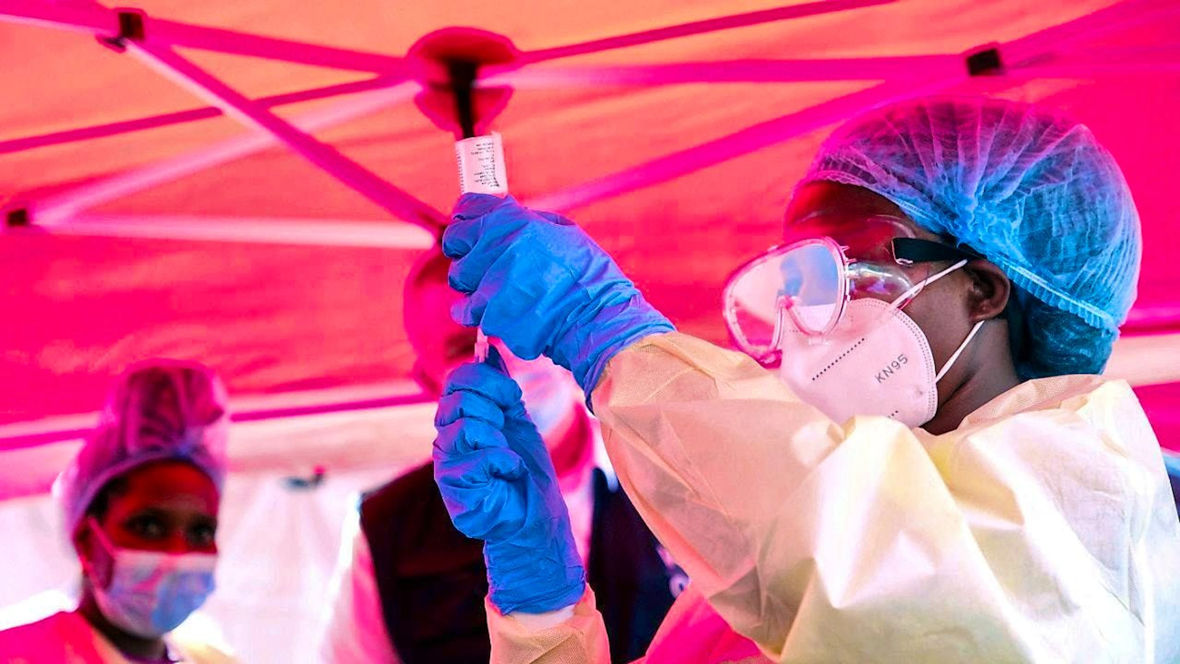 A health worker prepares to administer a vial of vaccine against the Sudanese strain of Ebola. Photo: Hajarah Nalwadda/AP/dpa
