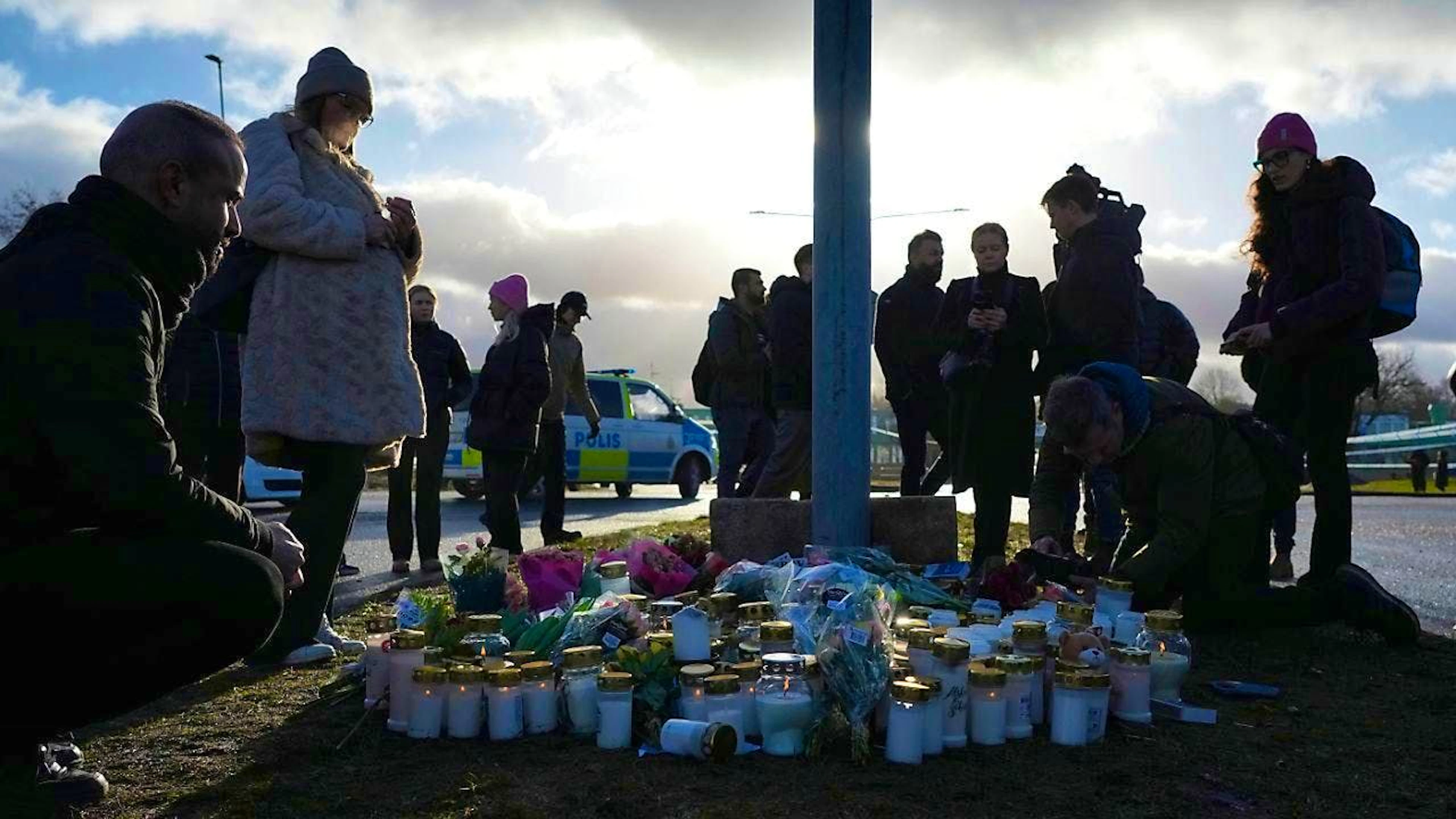 People gather at a makeshift memorial near the Campus Risbergska educational center. Photo: Sergei Grits/AP/dpa