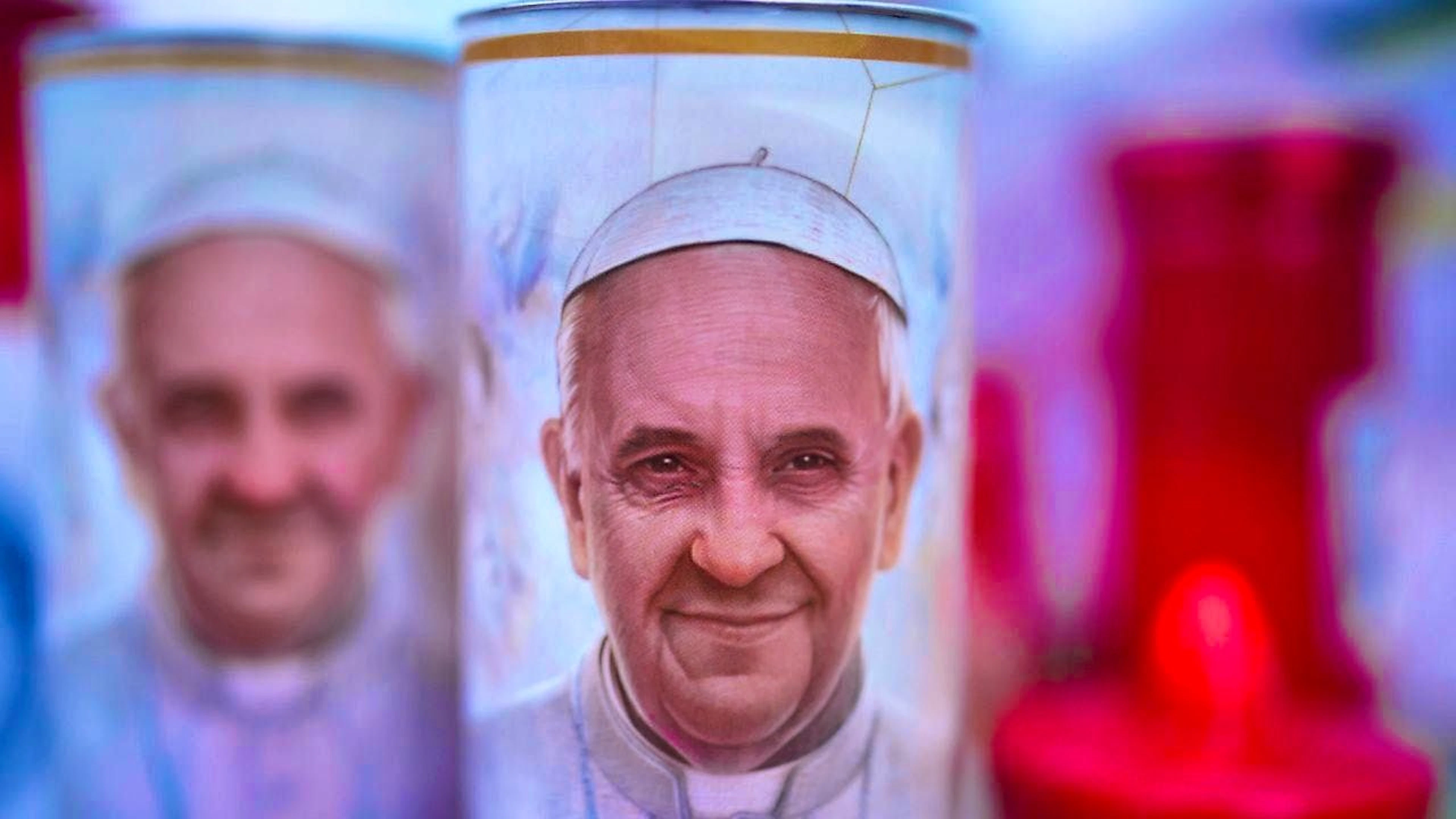 Candles with photos of Pope Francis.