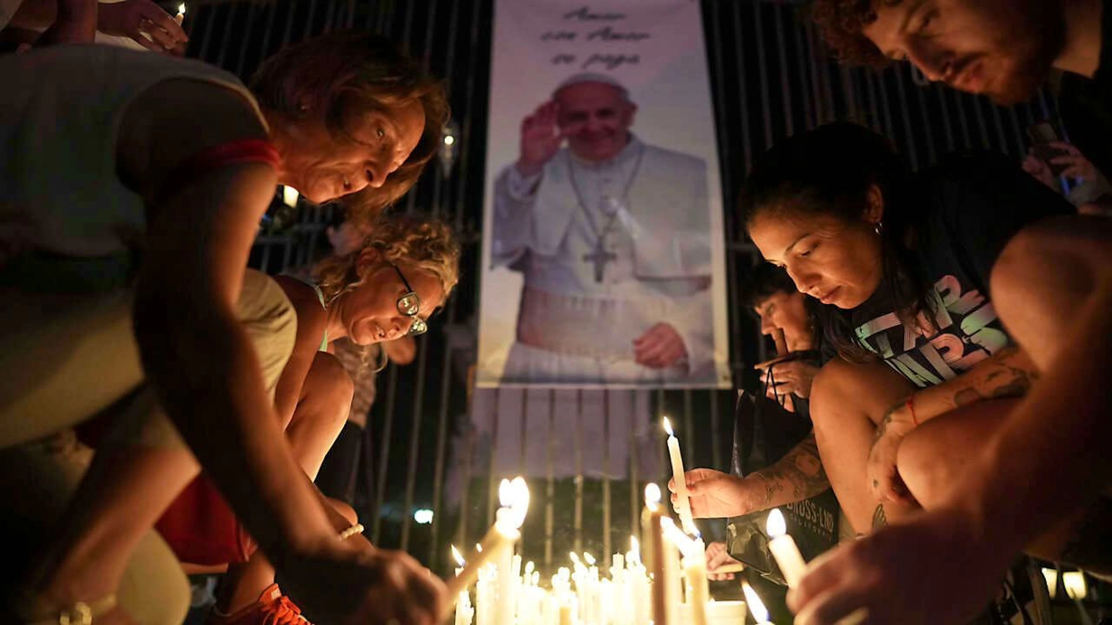 Gläubige zünden während einer Mahnwache in Buenos Aires Kerzen für Papst Franziskus an. Foto: Rodrigo Abd/AP/dpa