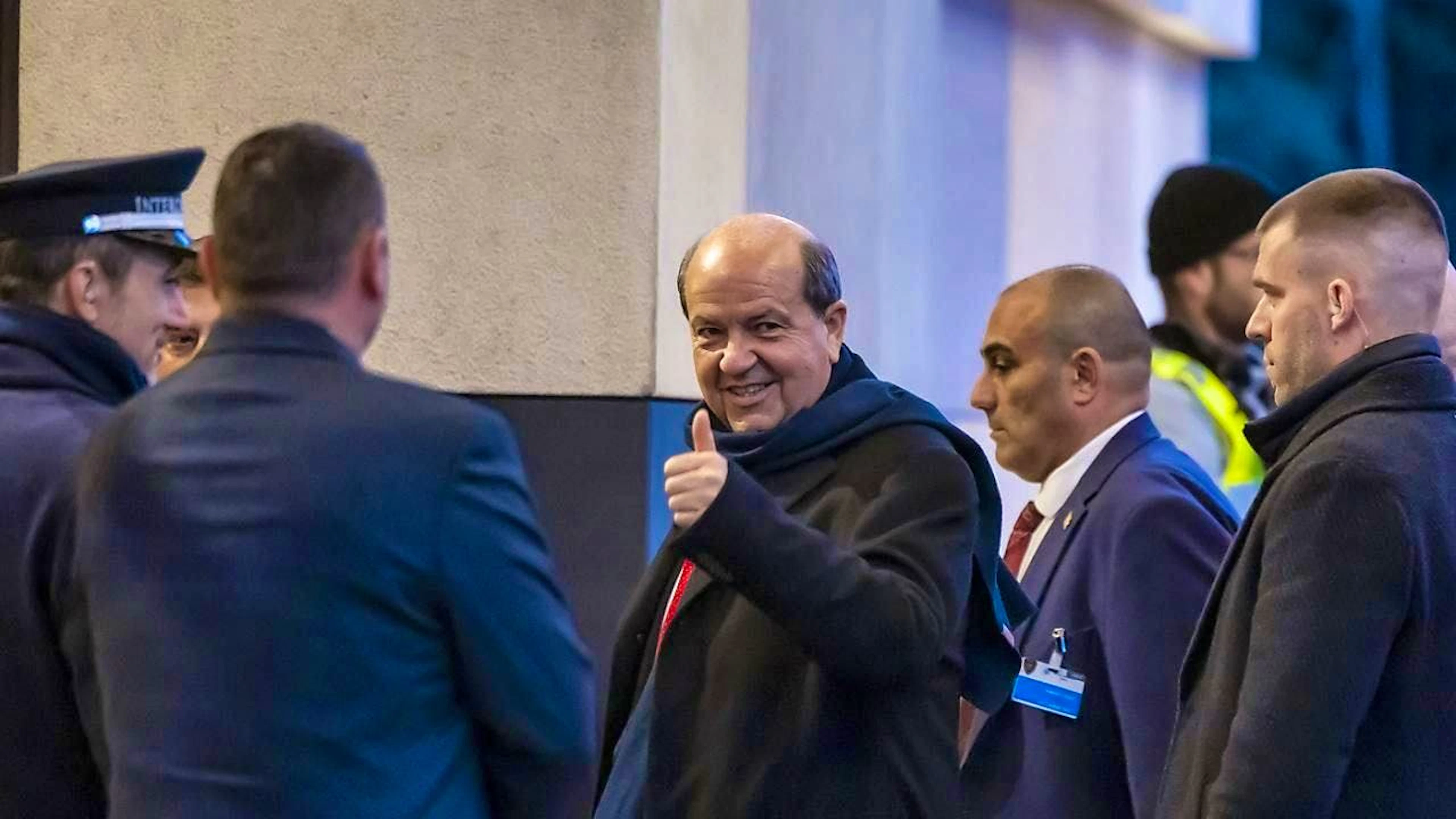 Turkish Cypriot leader Ersin Tatar (center) shows optimism despite low expectations for the informal meeting on Cyprus in Geneva.