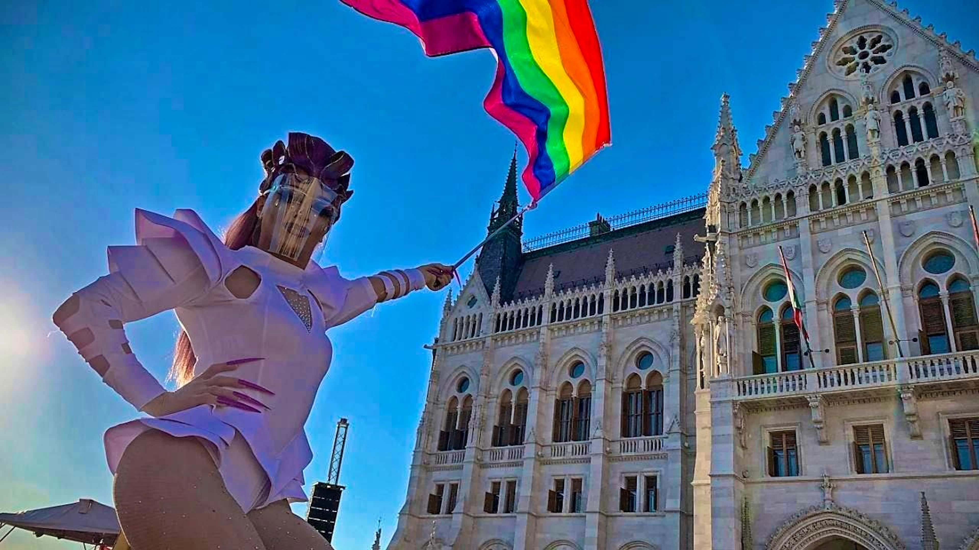 ARCHIVE - A participant waves a rainbow flag during a demonstration for LGBT rights in front of the Hungarian parliament building. Photo: Bela Szandelszky/AP/dpa