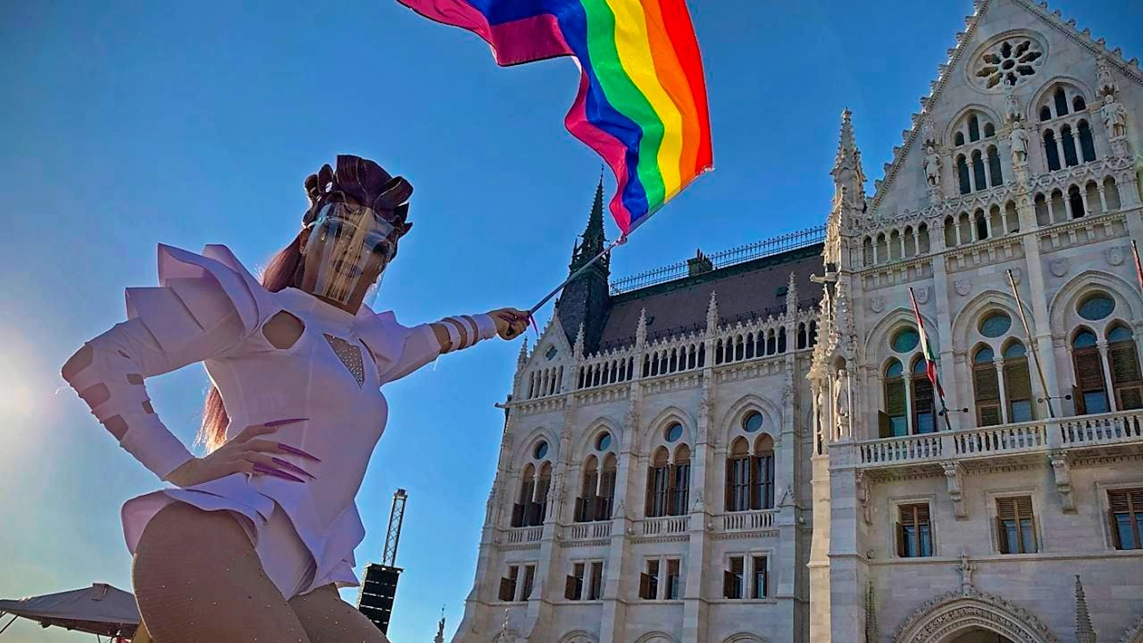 ARCHIV - Ein Teilnehmer schwenkt eine Regenbogenfahne während einer Demonstration für LGBT-Rechte vor dem ungarischen Parlamentsgebäude. Foto: Bela Szandelszky/AP/dpa