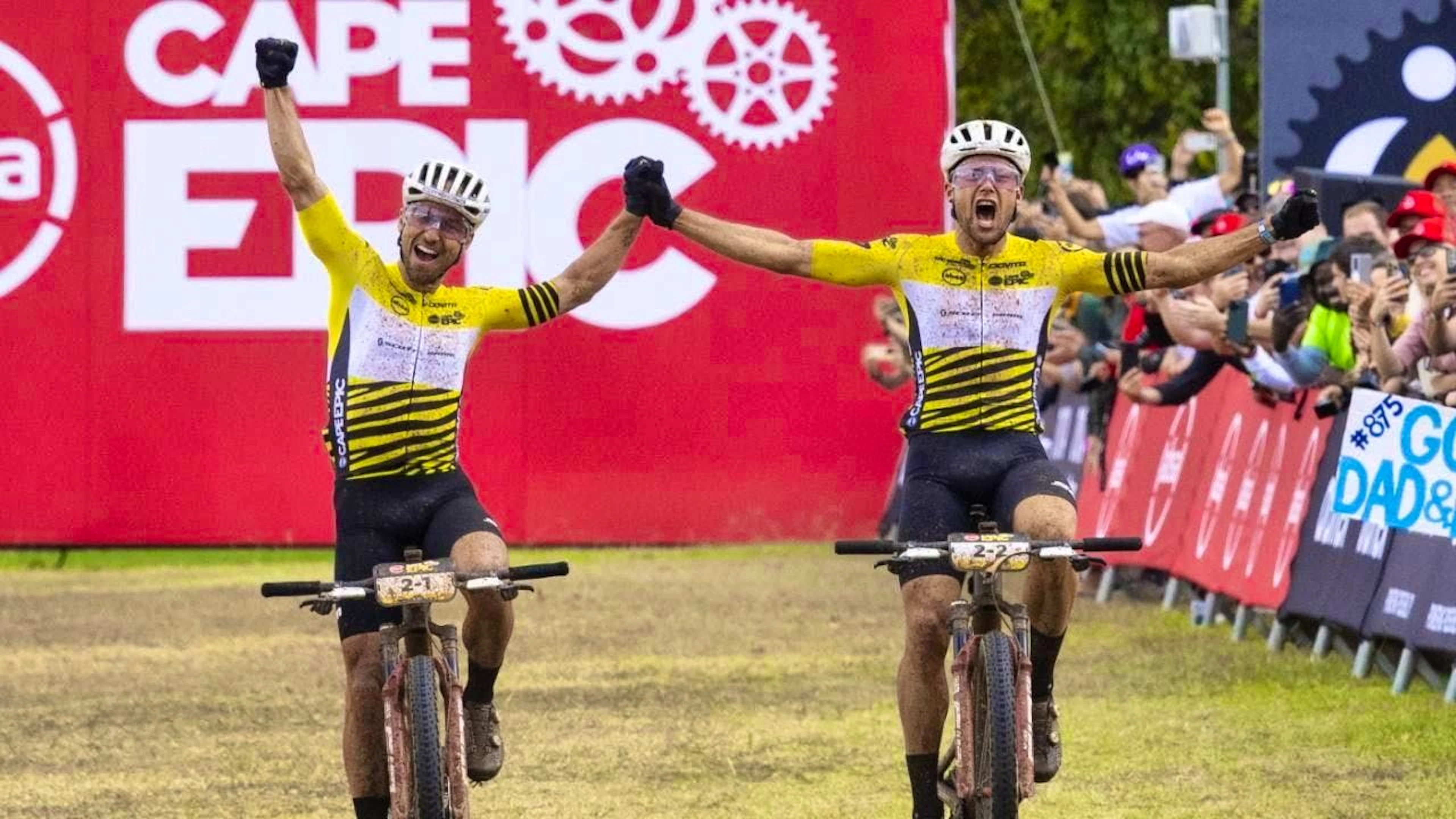 Nino Schurter (left) and Filippo Colombo cross the finish line at the Cape Epic as winners