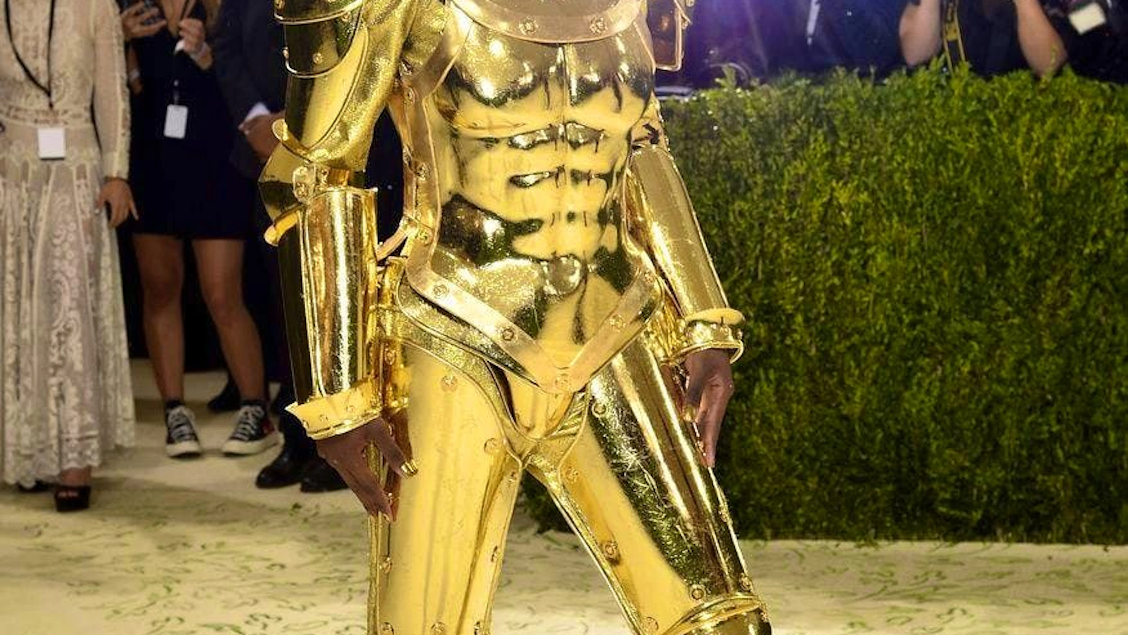 Shortly after walking the red carpet in his cape, Lil Nas took it off to reveal a golden suit of armor.