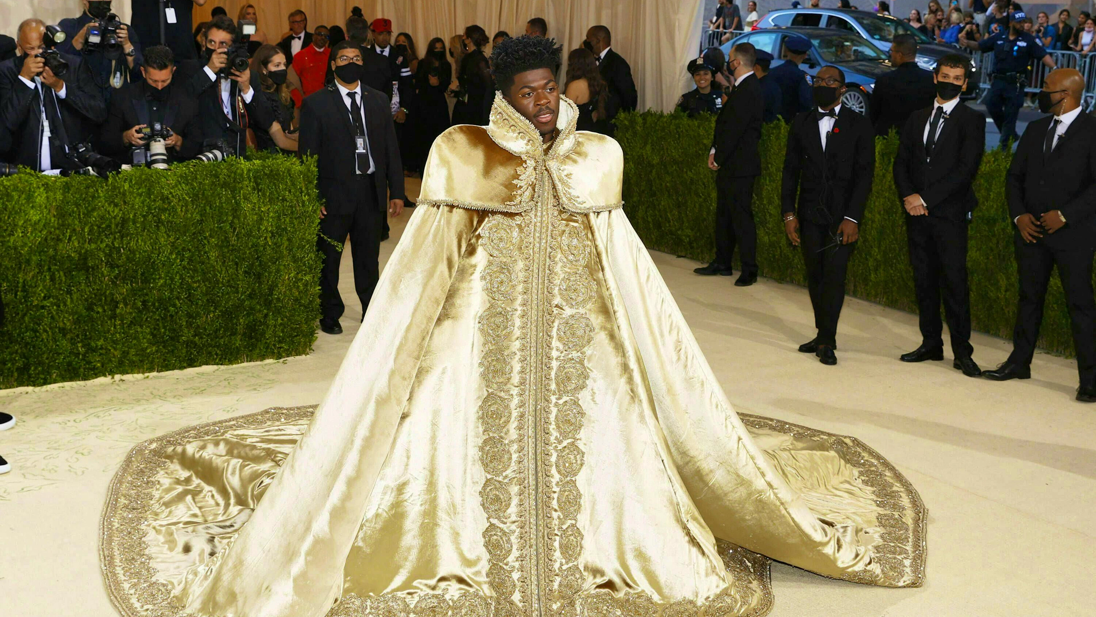 Rapper Lil Nas X wore a regal-looking cape with golden embroidery at the 2021 MET Gala.