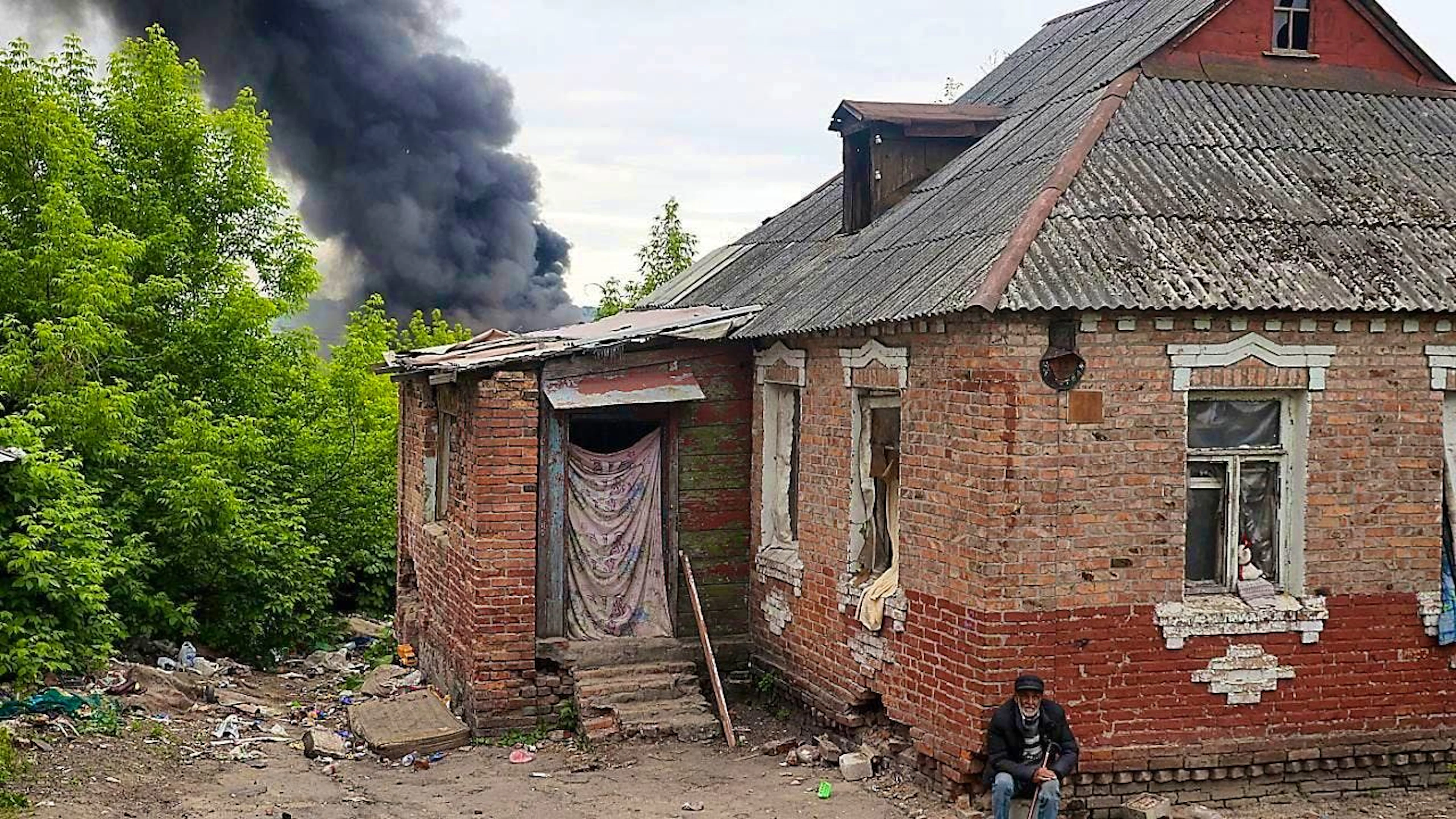 ARCHIVE - A column of smoke rises behind a house after shelling by Russian troops. Photo: -/ukrin/dpa/Archive image