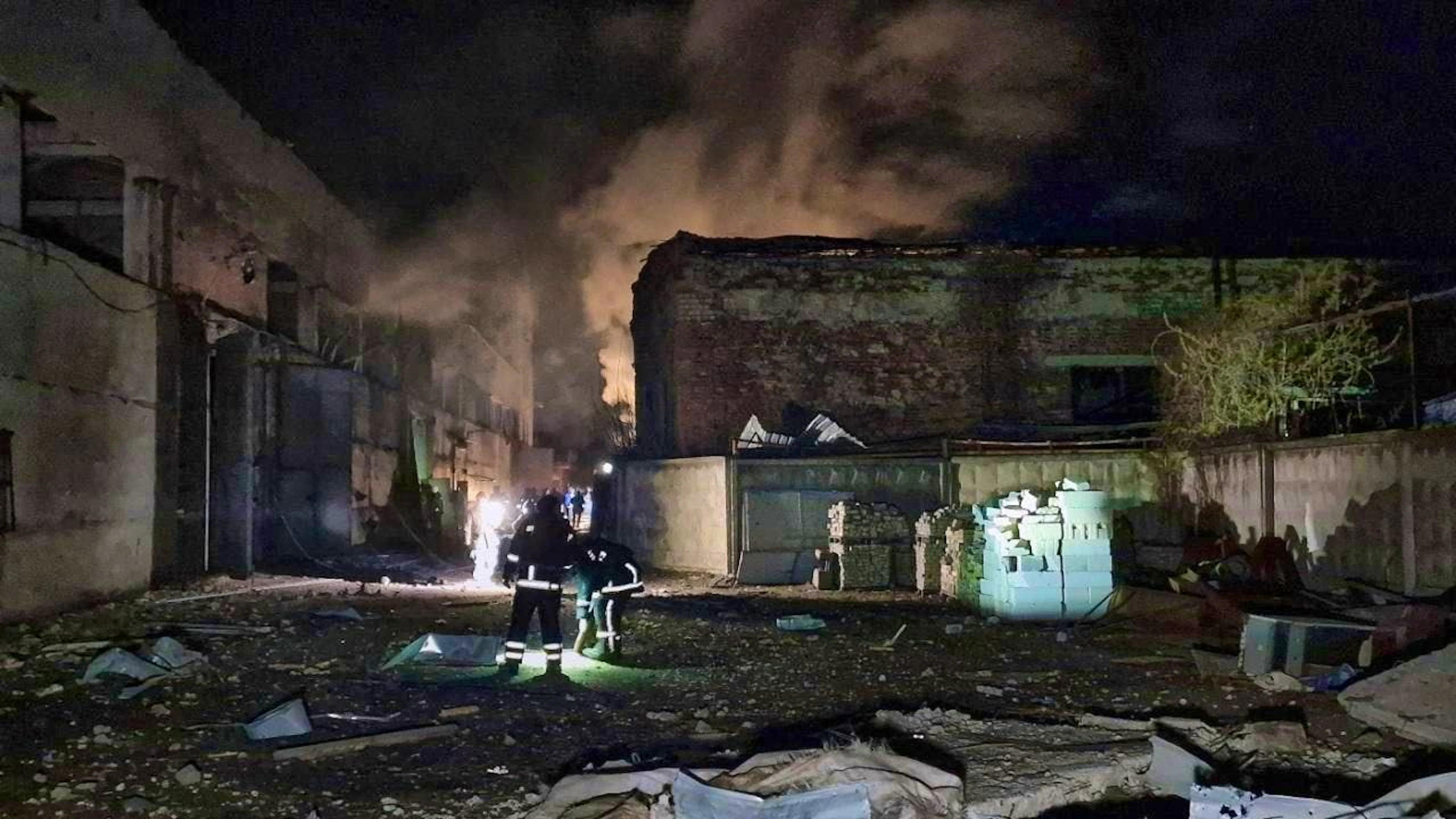 ARCHIVE - Two firefighters stand at the site of a Russian drone attack. Photo: Viacheslav Madiievskyi/Ukrinform/dpa