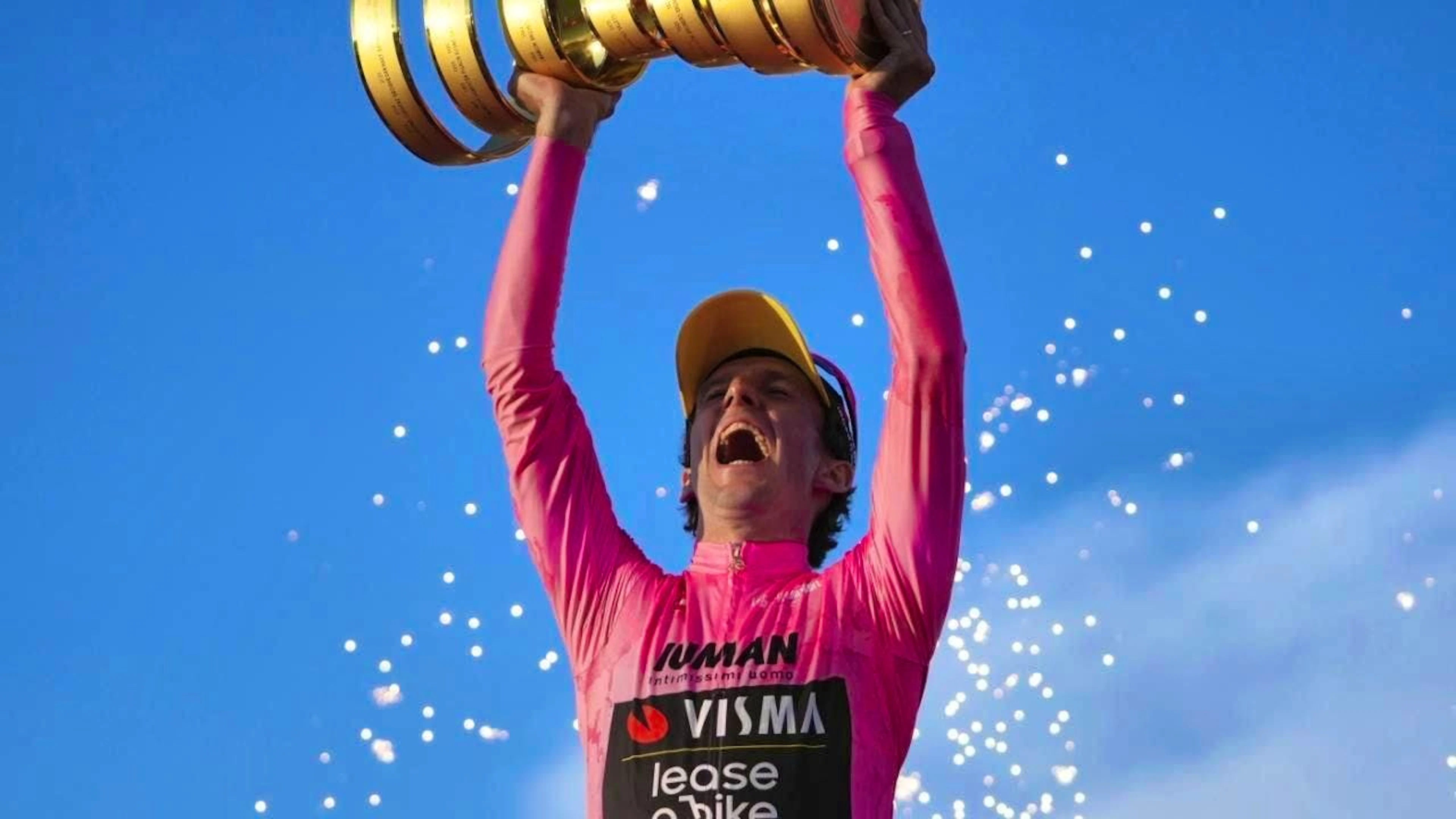 Simon Yates lifts the Giro d'Italia winner's trophy
