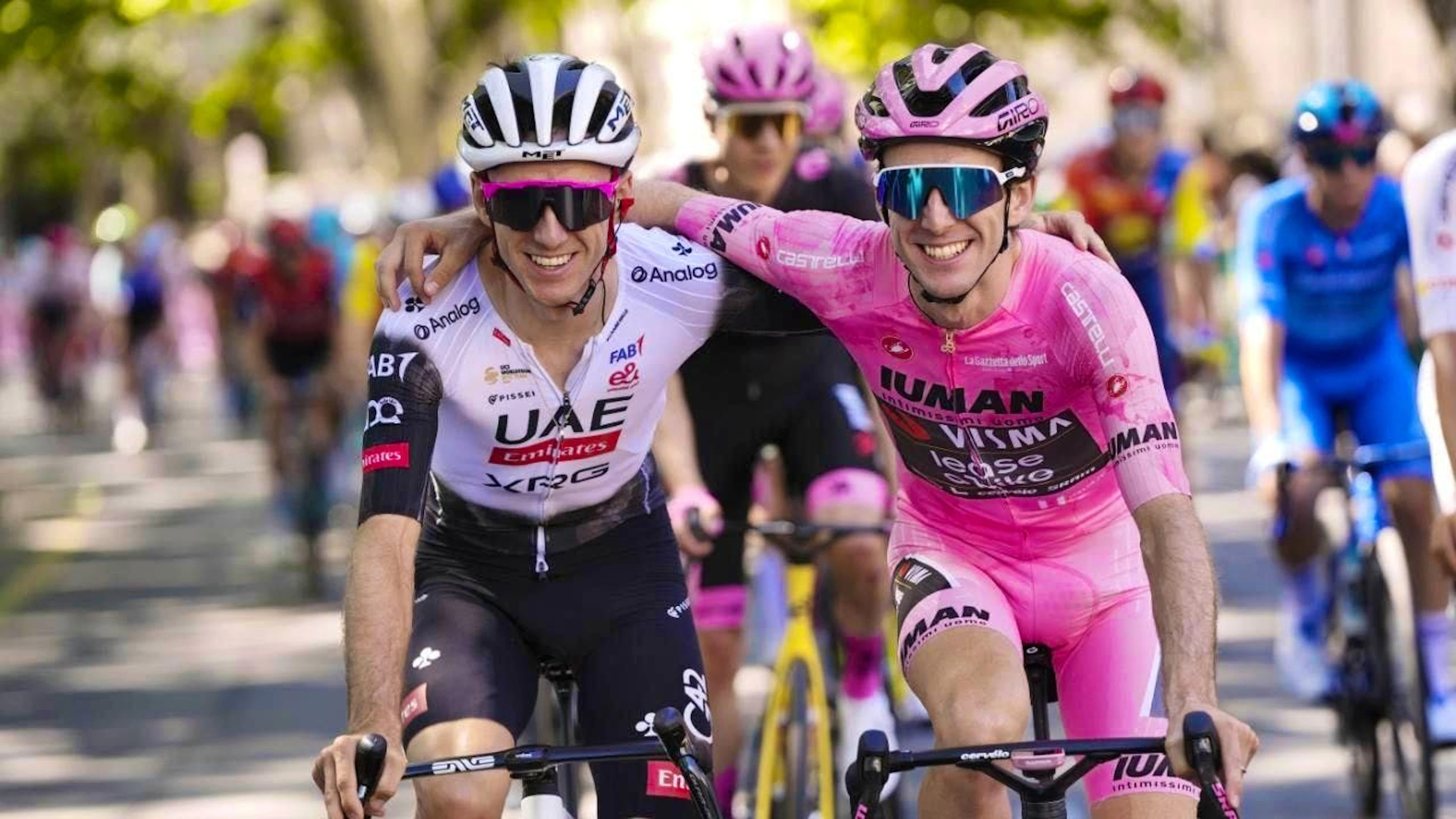 Simon Yates (right) and his twin brother Adam arm in arm on the final stage