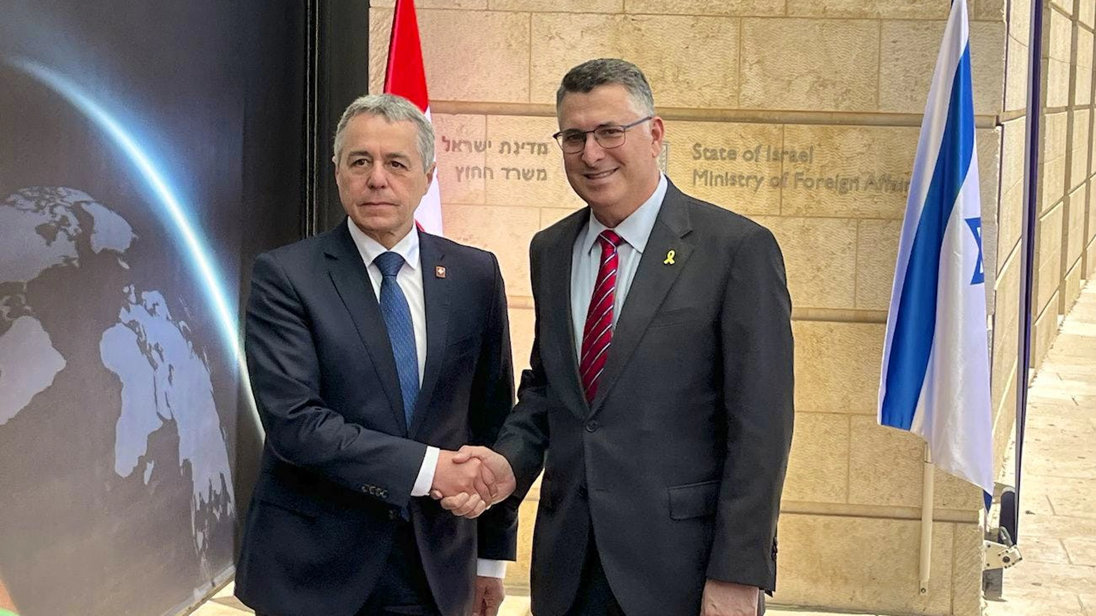 Switzerland's Foreign Minister Federal Councillor Ignazio Cassis, left, shakes hands with Israel's Foreign Minister Gideon Sa'ar, right, in Jerusalem, Israel, Wednesday, June 11, 2025. The Swiss Foreign minister is on a two-days visit to Israel and the Palestinian territories. (KEYSTONE/Laurent Sierro)