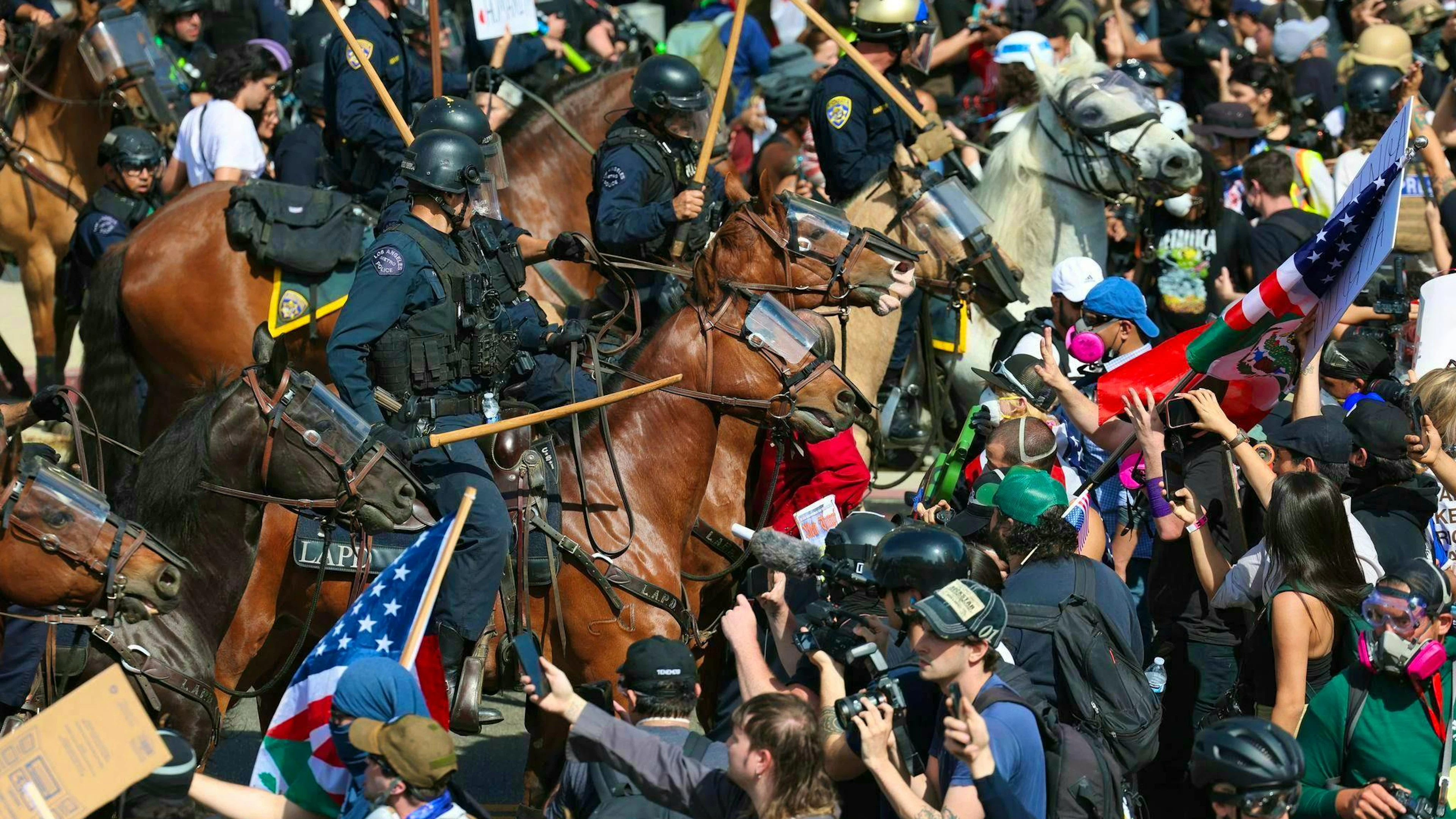 Demonstrators clash with mounted police in Los Angeles.