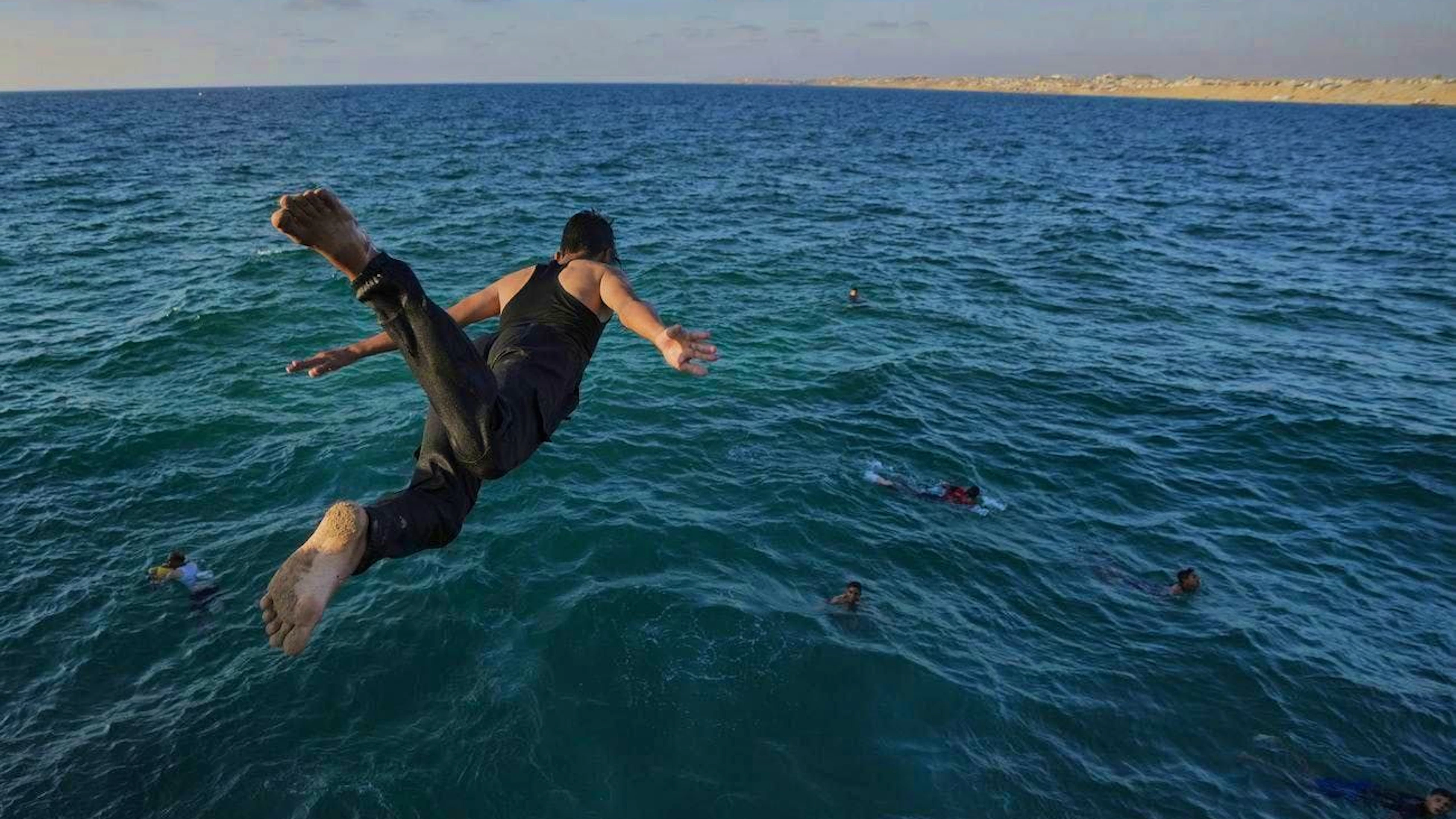 Palestinians look to cool off in the Mediterranean Sea near Chan Junis on July 2.
