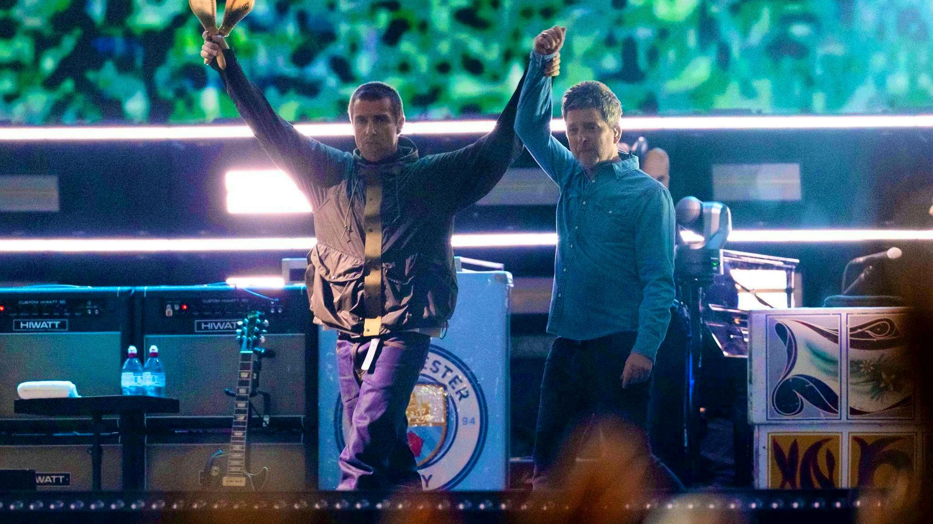 Reunited at last: Liam and Noel Gallagher on stage.