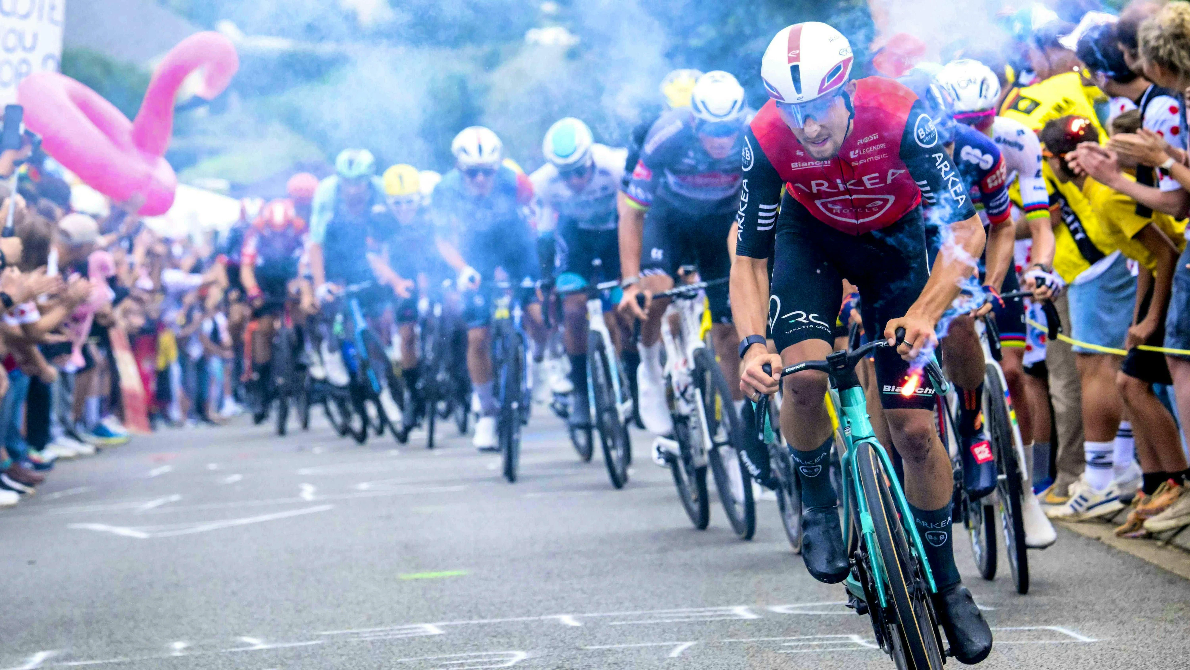 Obscured view: fans set off smoke bombs on the roadside of the Tour de France.