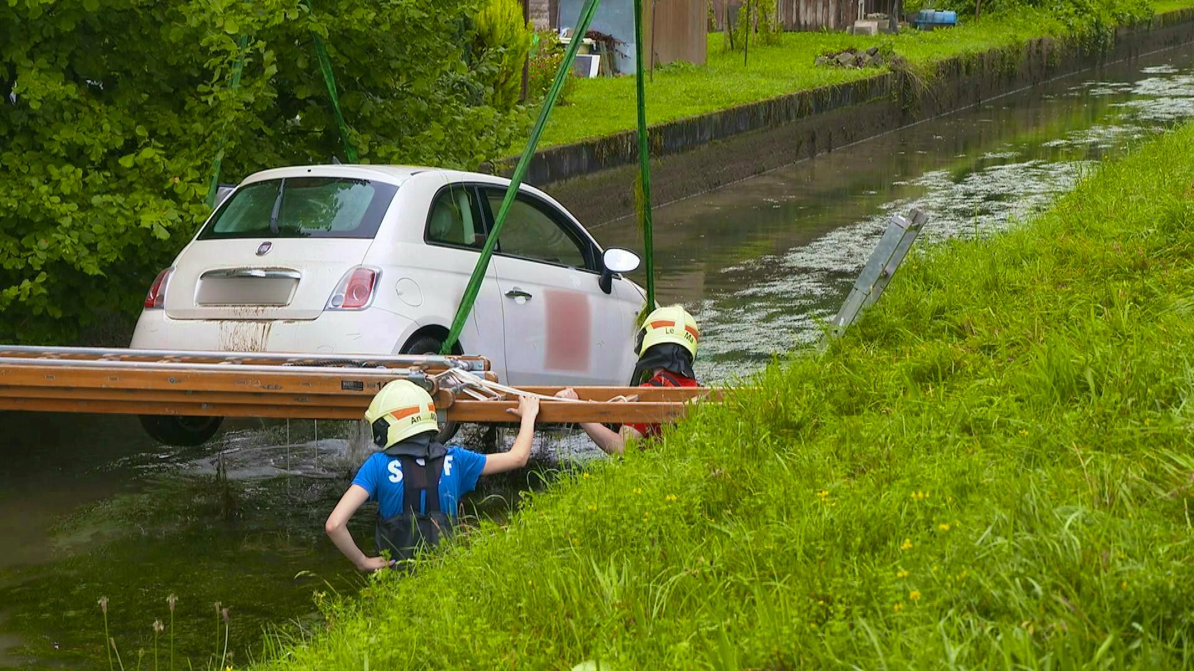 The car was pulled out of the water with a crane. 