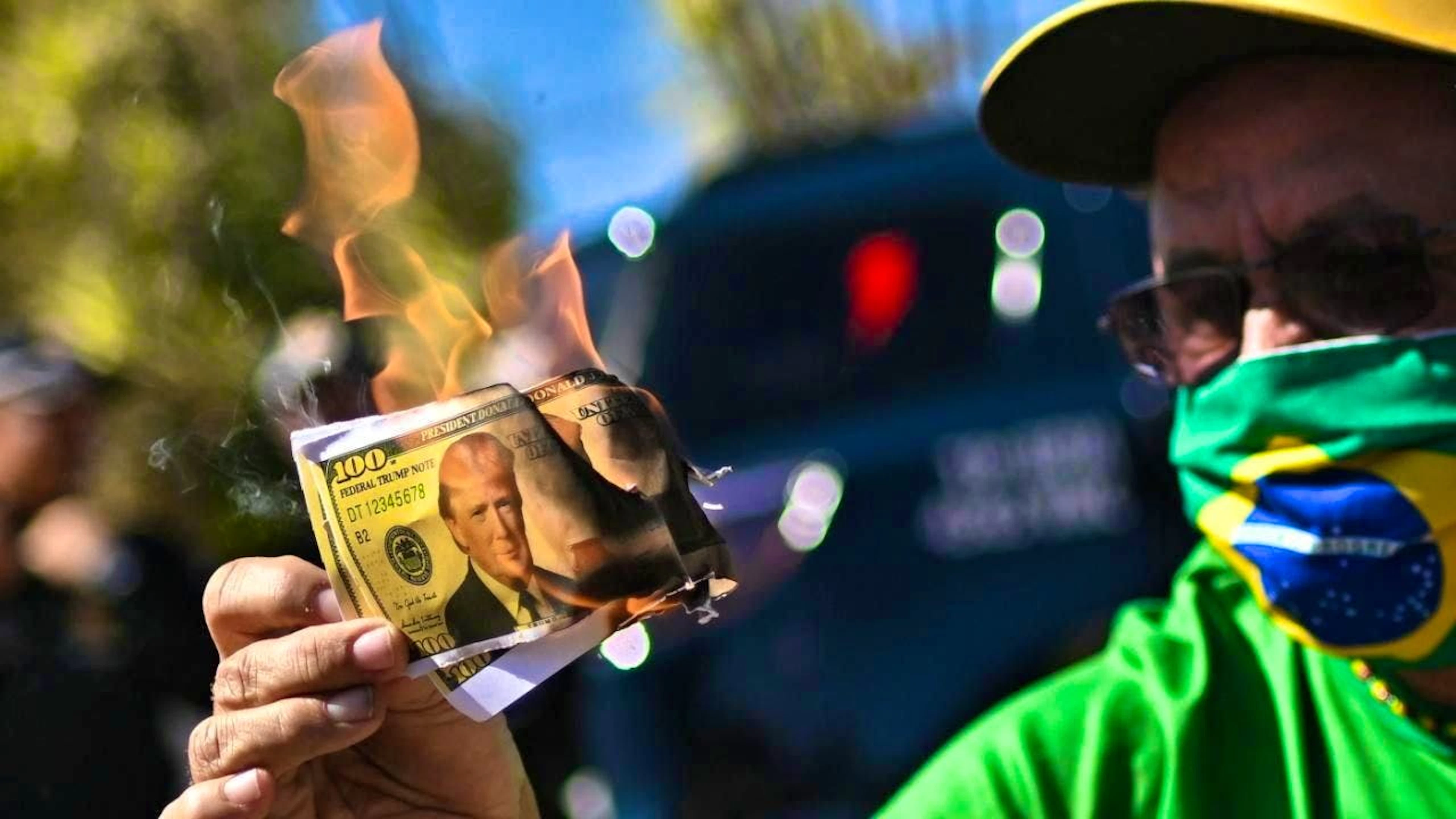 Demonstrators in Brazil set fire to fake dollar bills, among other things.