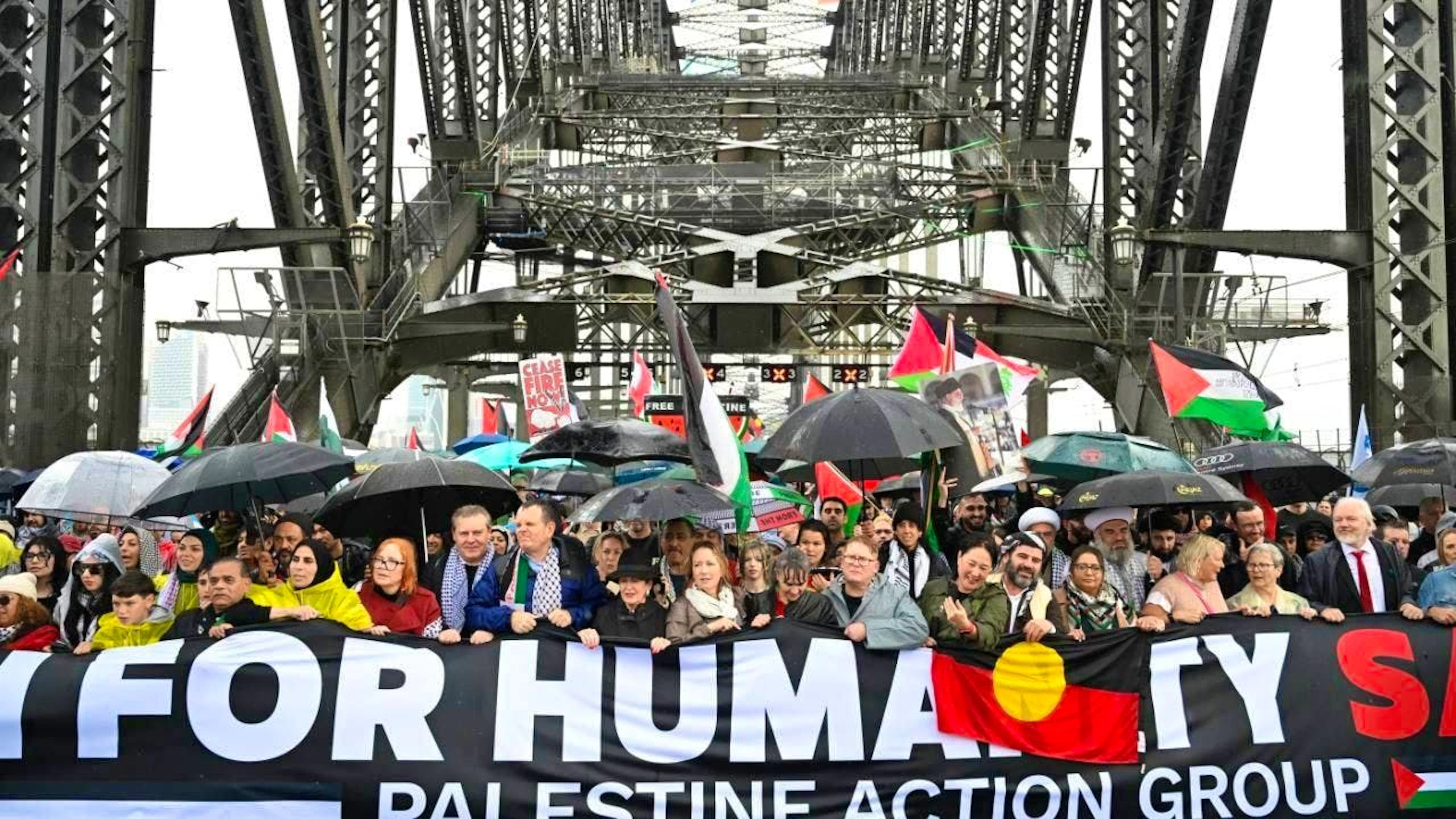 Protesters cross the Sydney Harbour Bridge during the Palestine Action Group's March for Humanity in Sydney, with WikiLeaks founder Julian Assange (r) among them. Photo: Dean Lewins/AAP/dpa