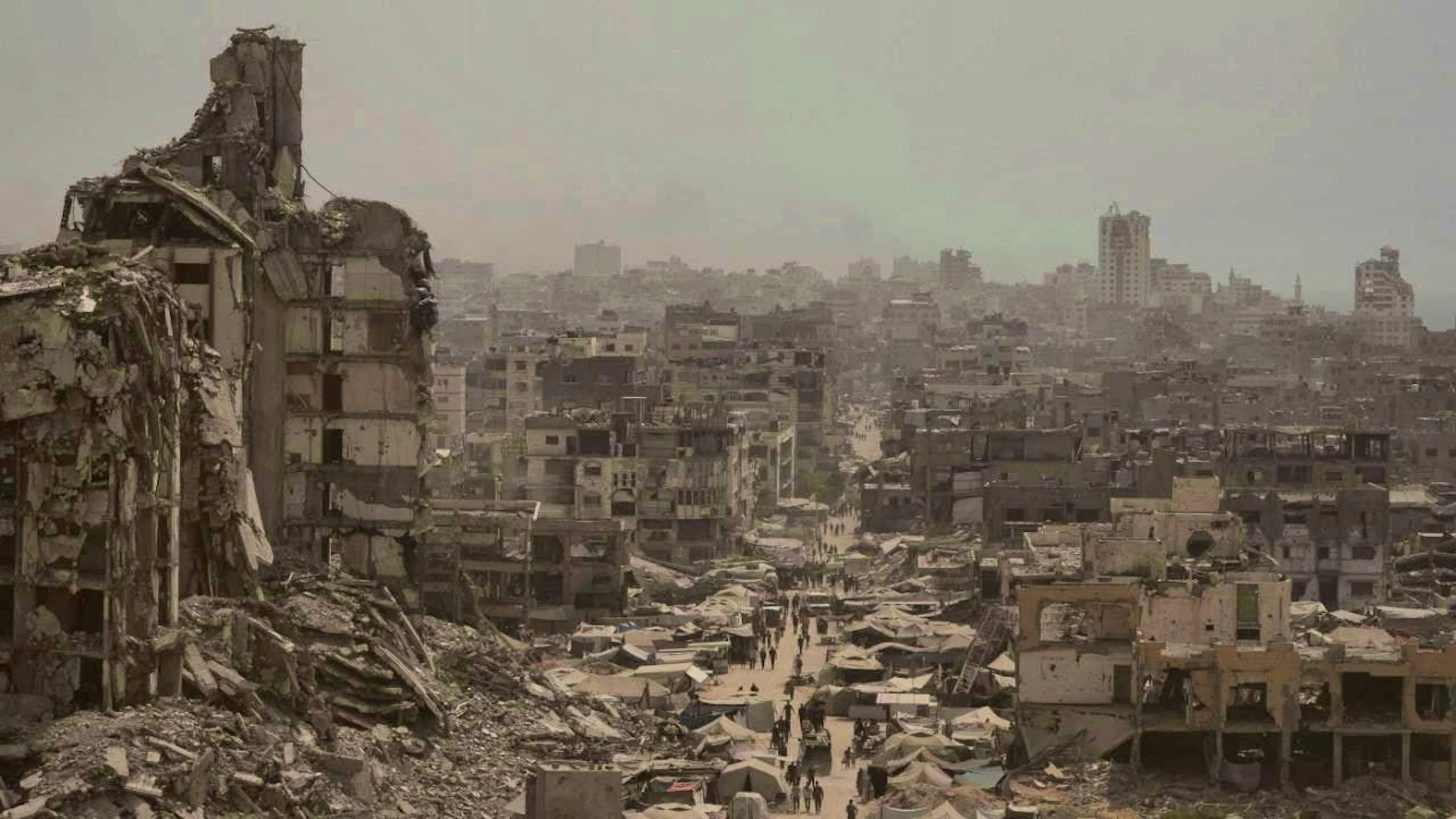 ARCHIVE - People walk along a street surrounded by buildings destroyed by Israeli bombardment in the Gaza Strip. Photo: Jehad Alshrafi/AP/dpa