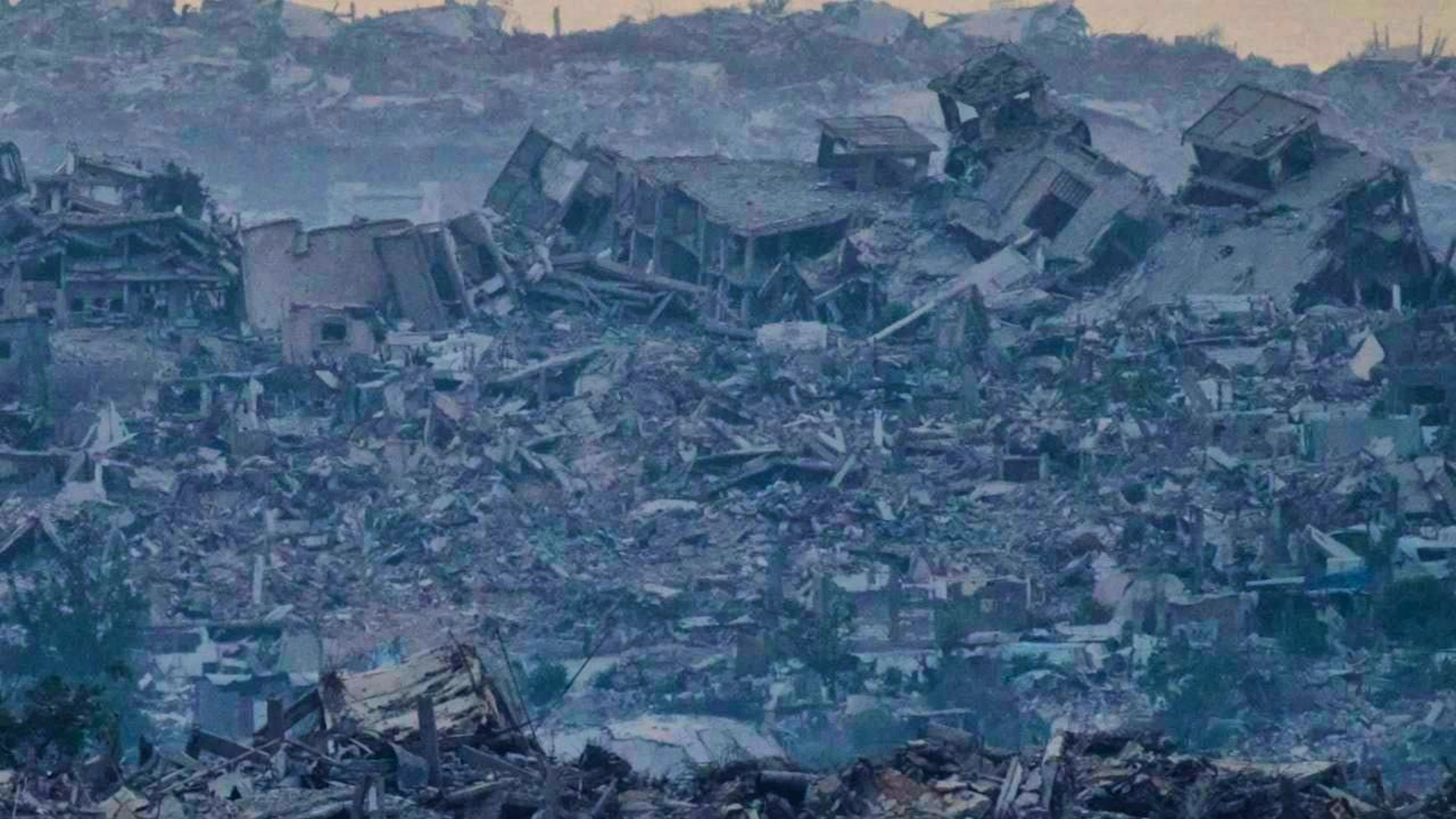 Buildings destroyed during Israeli ground and air operations stand in the northern Gaza Strip, as seen from southern Israel. Photo: Leo Correa/AP/dpa