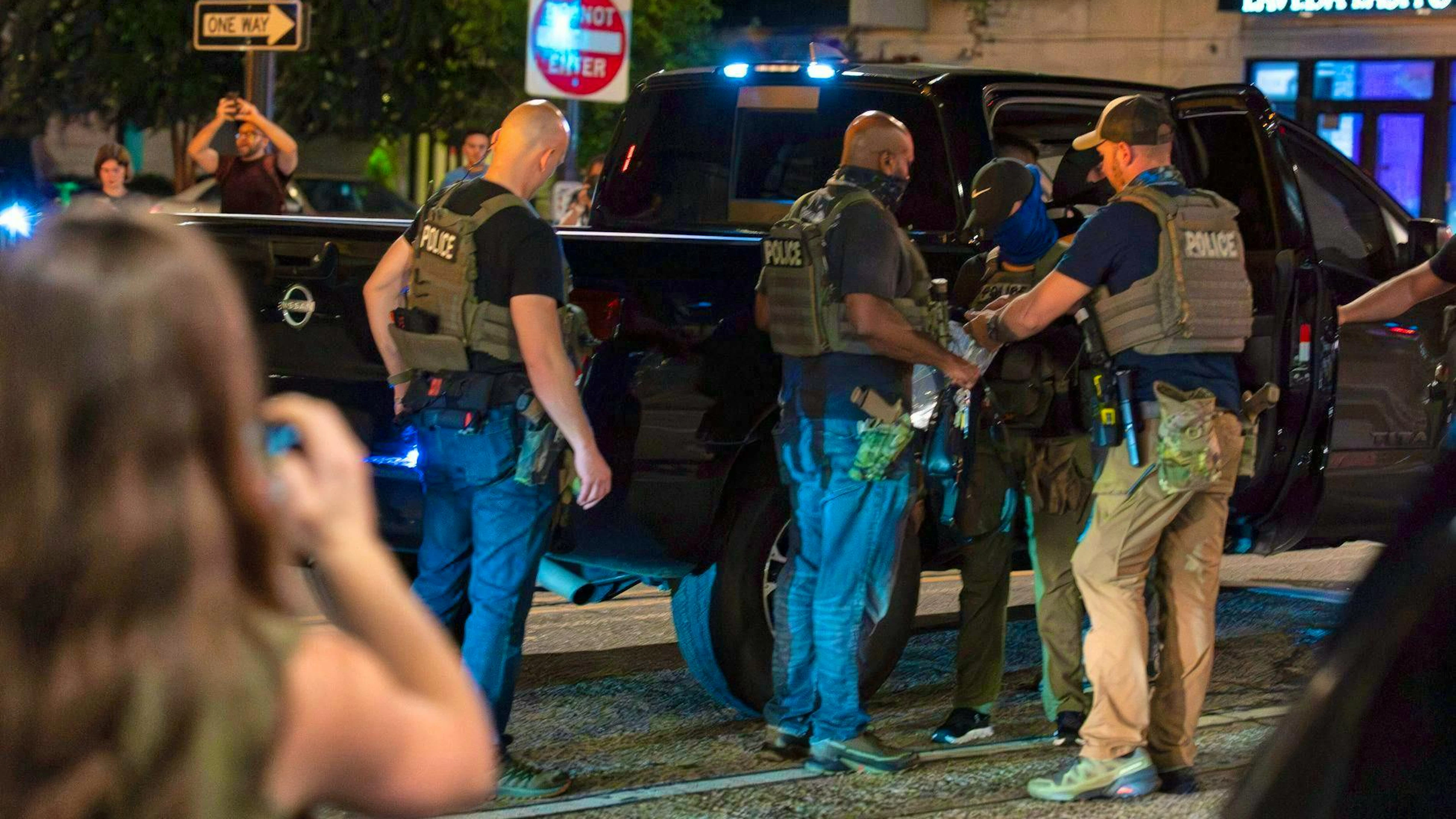 Dozens of people are arrested in the process.