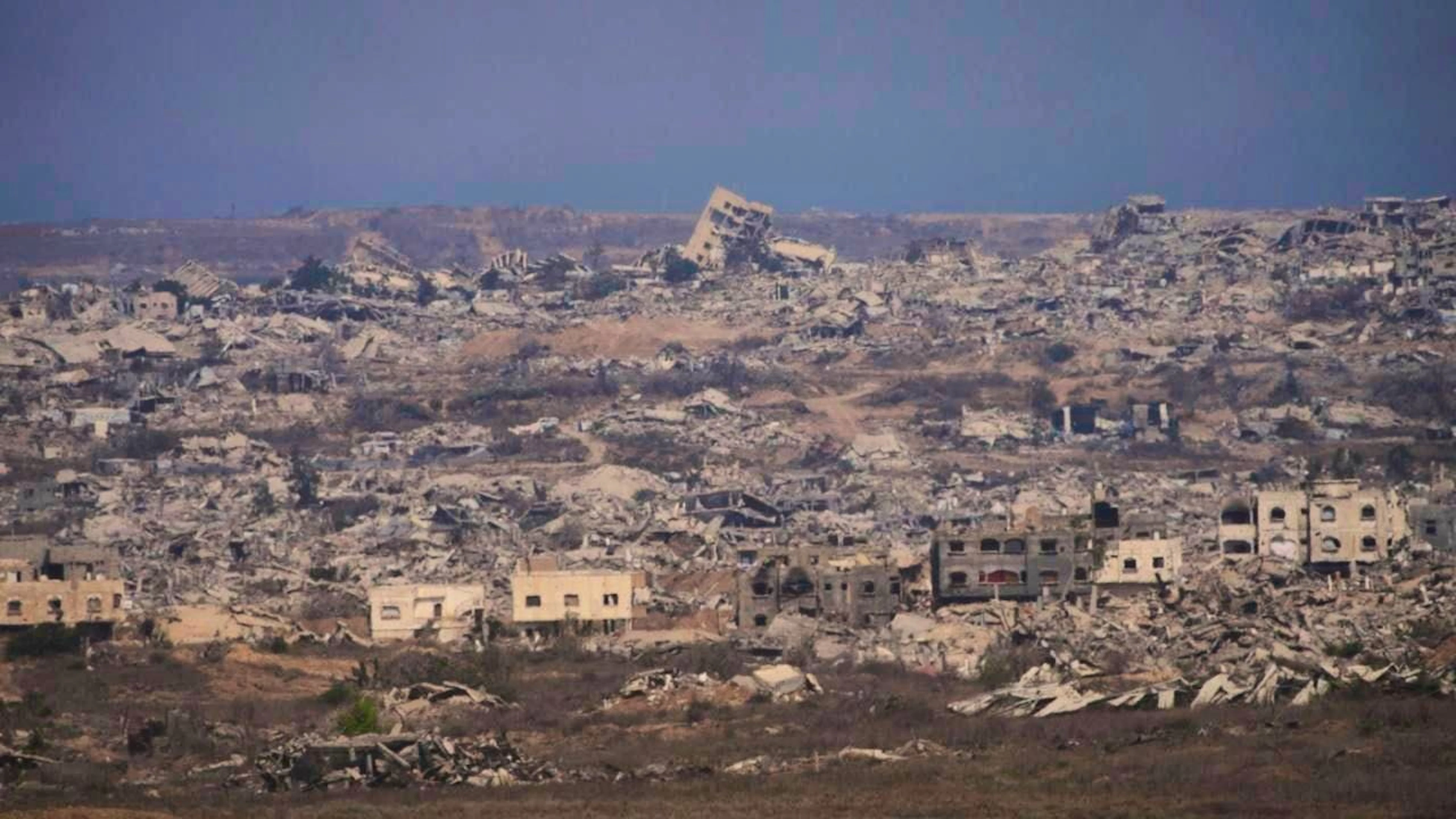 ARCHIVE - Destroyed buildings in the Gaza Strip, seen from southern Israel. Photo: Ariel Schalit/AP/dpa/Archive image