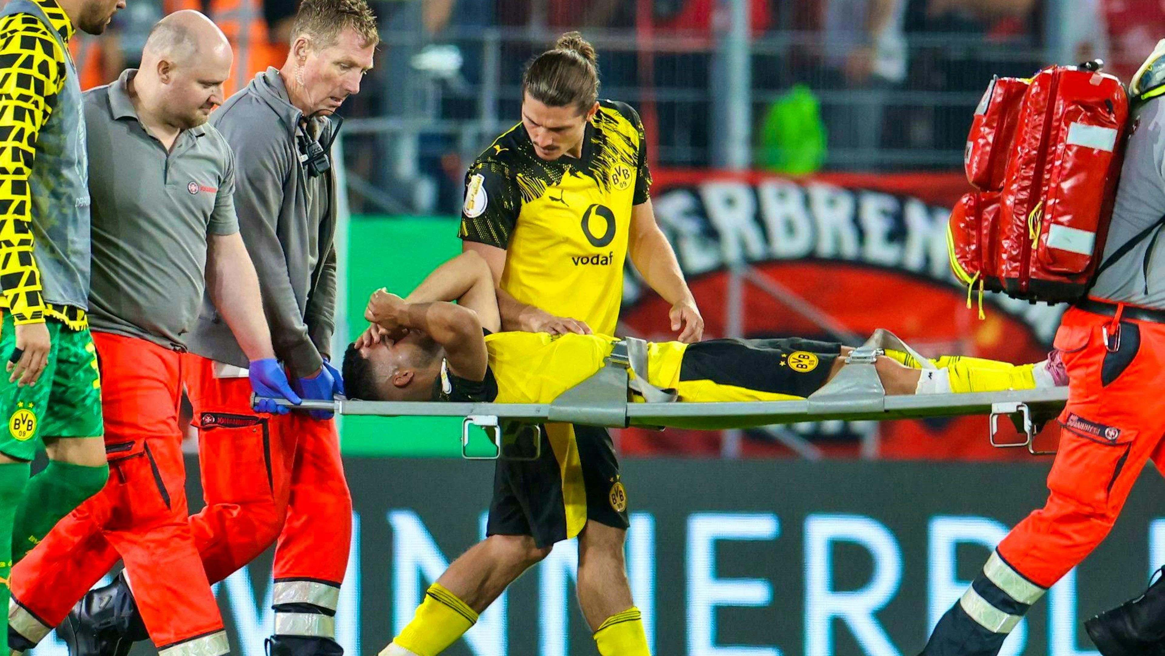Yan Couto has to be stretchered off the pitch.