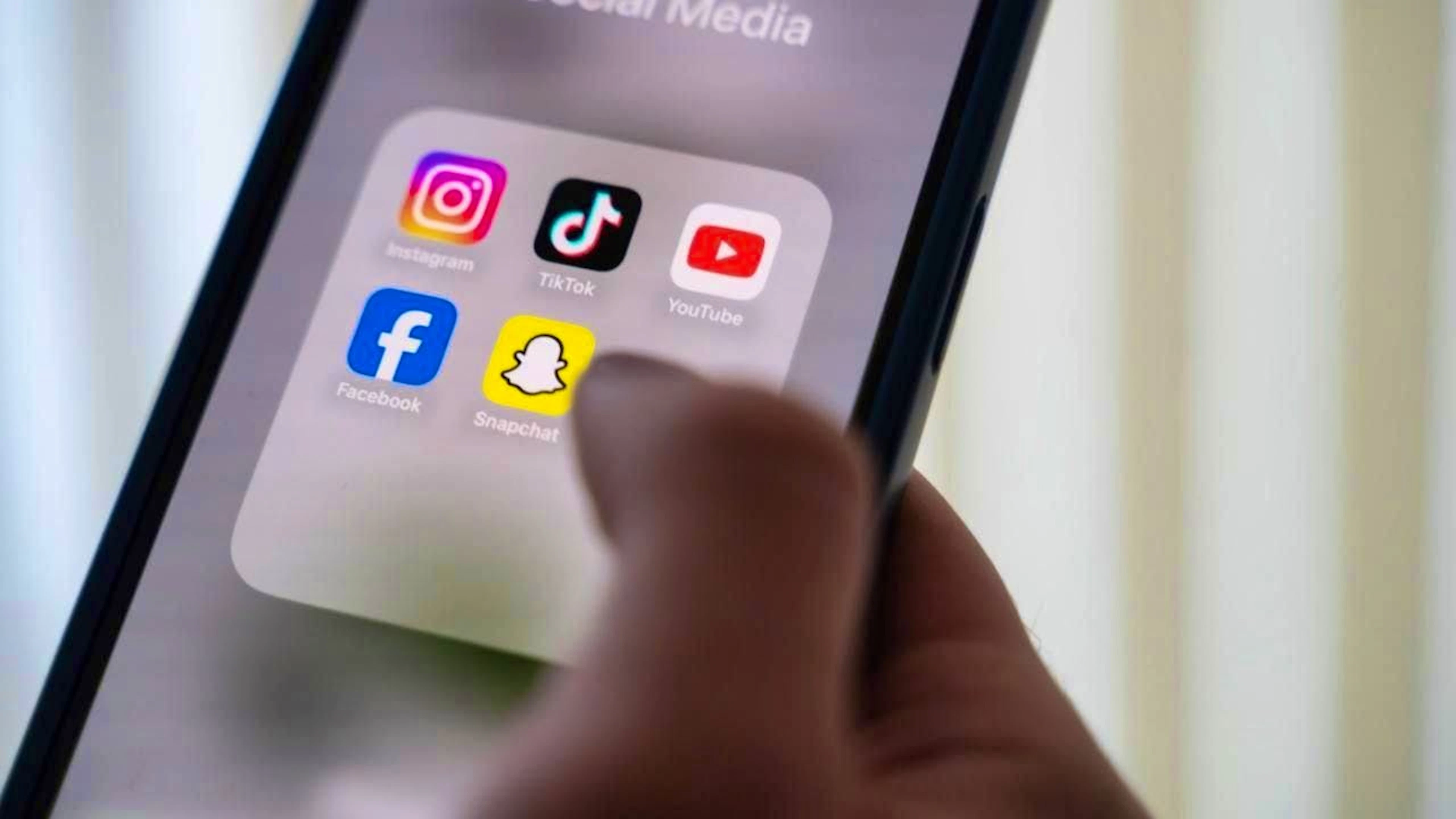 ARCHIVE - A woman holds a smartphone with various social media apps on the display. Photo: Alicia Windzio/dpa