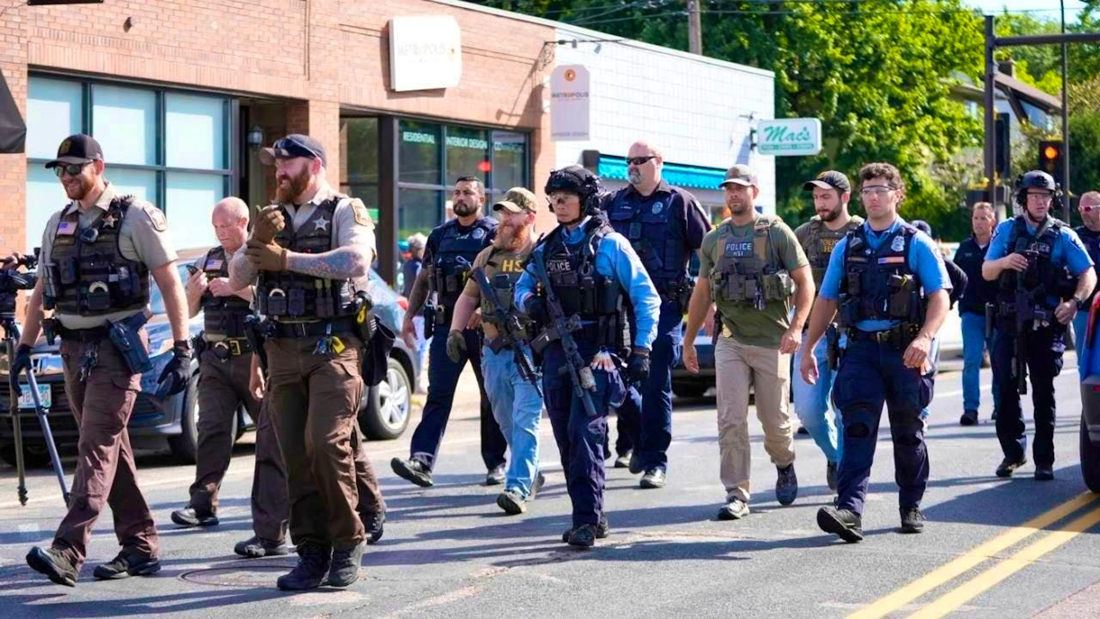 Police officers arrive at the scene after fatal shooting at a school. Photo: Abbie Parr/AP/dpa